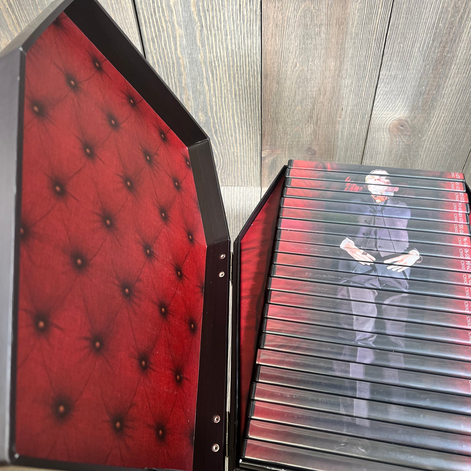 DVD set of "Dark Shadows: The Complete Original Series" in a coffin-shaped box with red interior and character image.