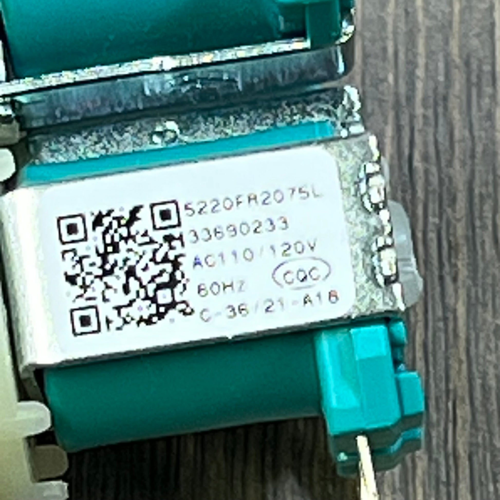 Close-up of the 1045811647-5220FR2075L cold water inlet valve for LG and Kenmore washers, showing model number and voltage details.