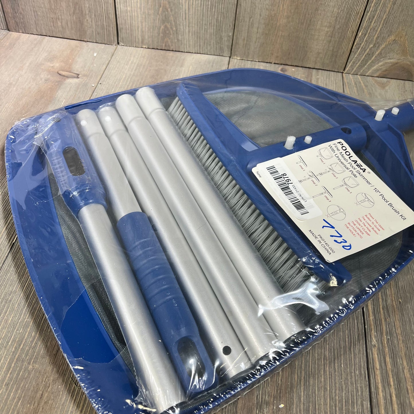 "Poolaza 3-in-1 Pool Cleaning Kit with skimmer net, brush, and 50'' pole in packaging on wooden surface."