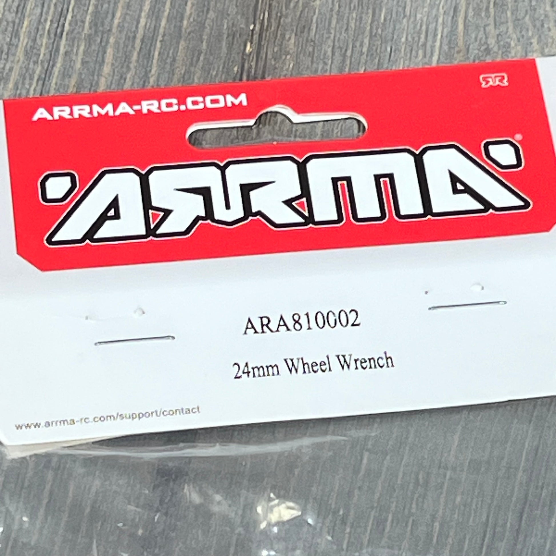 ARRMA 24mm Wheel Wrench packaging, model ARA810002, featuring bold red and white branding against a wood background.