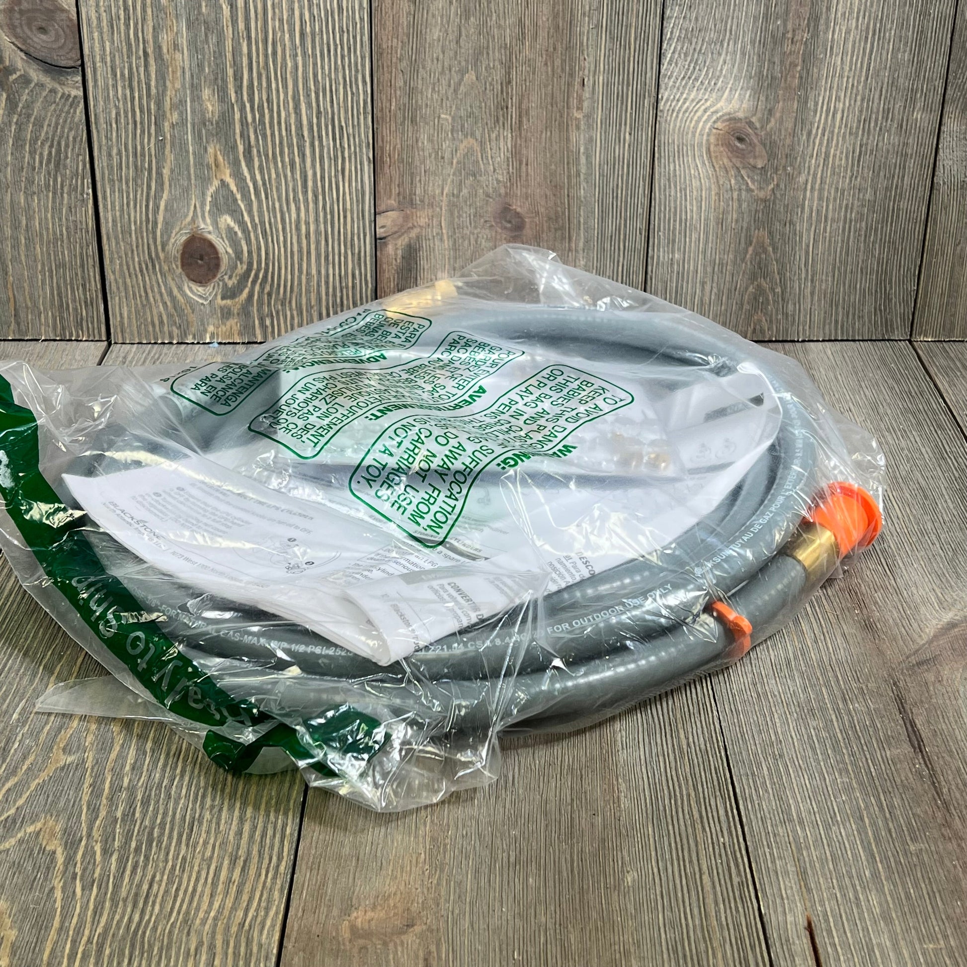 Gray Blackstone 5249 conversion kit for propane to natural gas, includes hose and fittings in packaging.