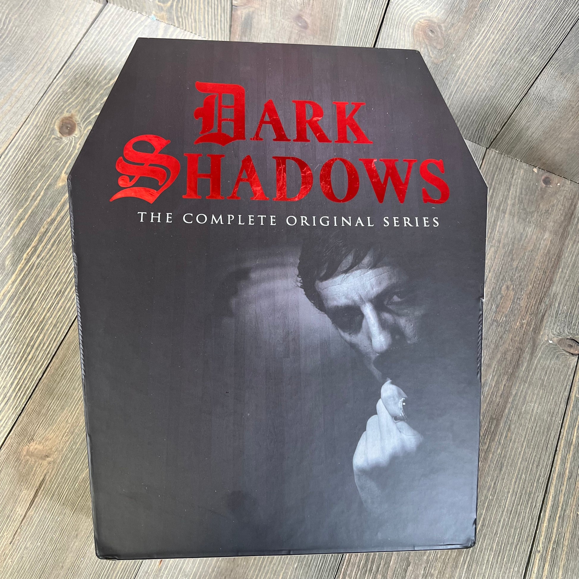 "Dark Shadows: The Complete Original Series" DVD set in a coffin-shaped box with a dark, mysterious design.