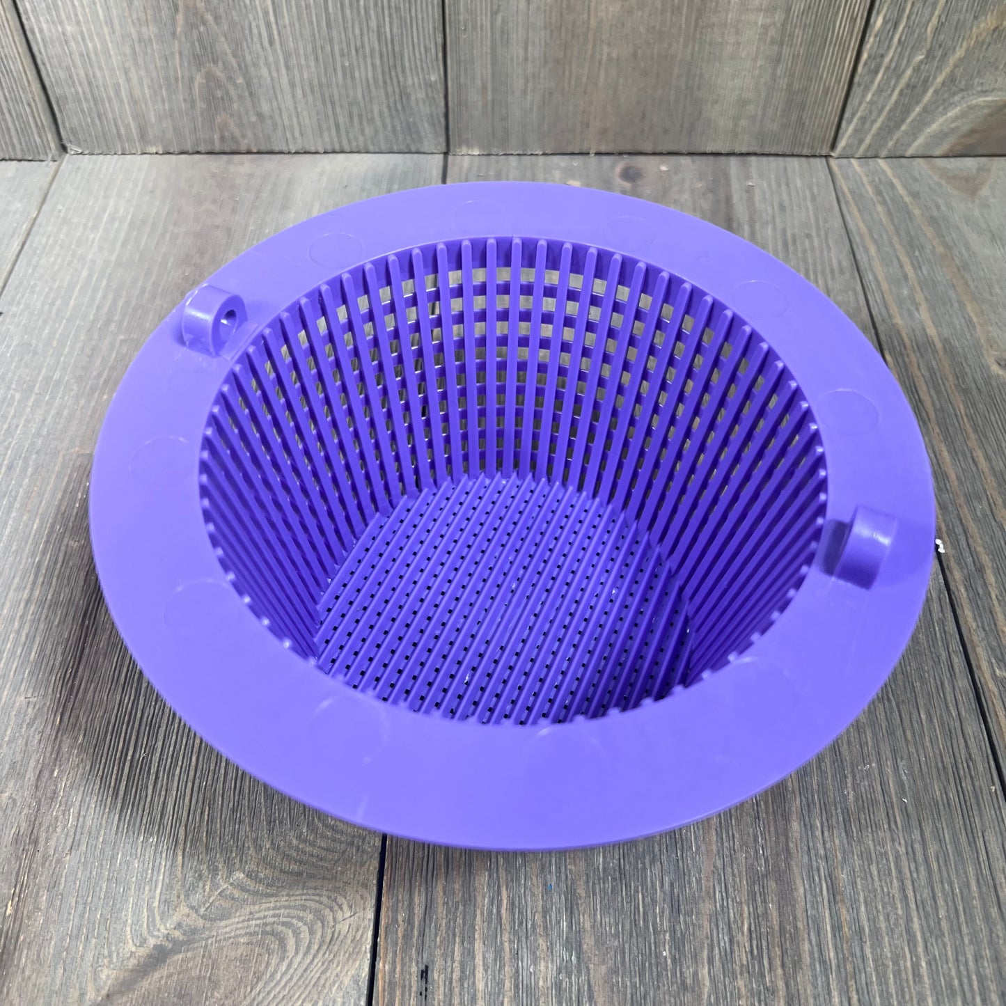 Purple pool skimmer basket with handle, 6.18-inch top diameter, on wooden surface.