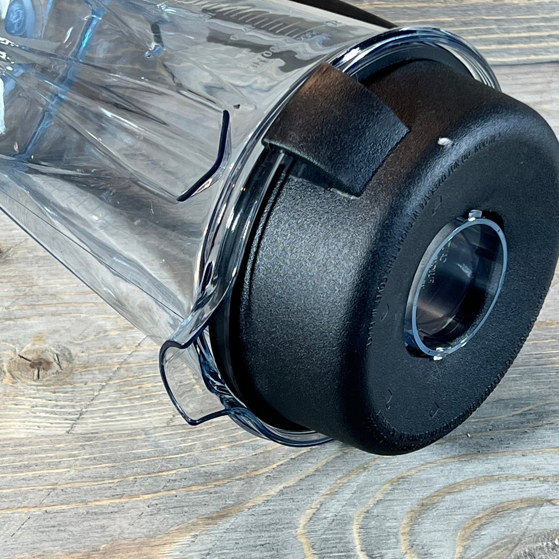 64oz replacement blender pitcher for Vitamix, featuring sturdy black lid on a rustic wooden surface.