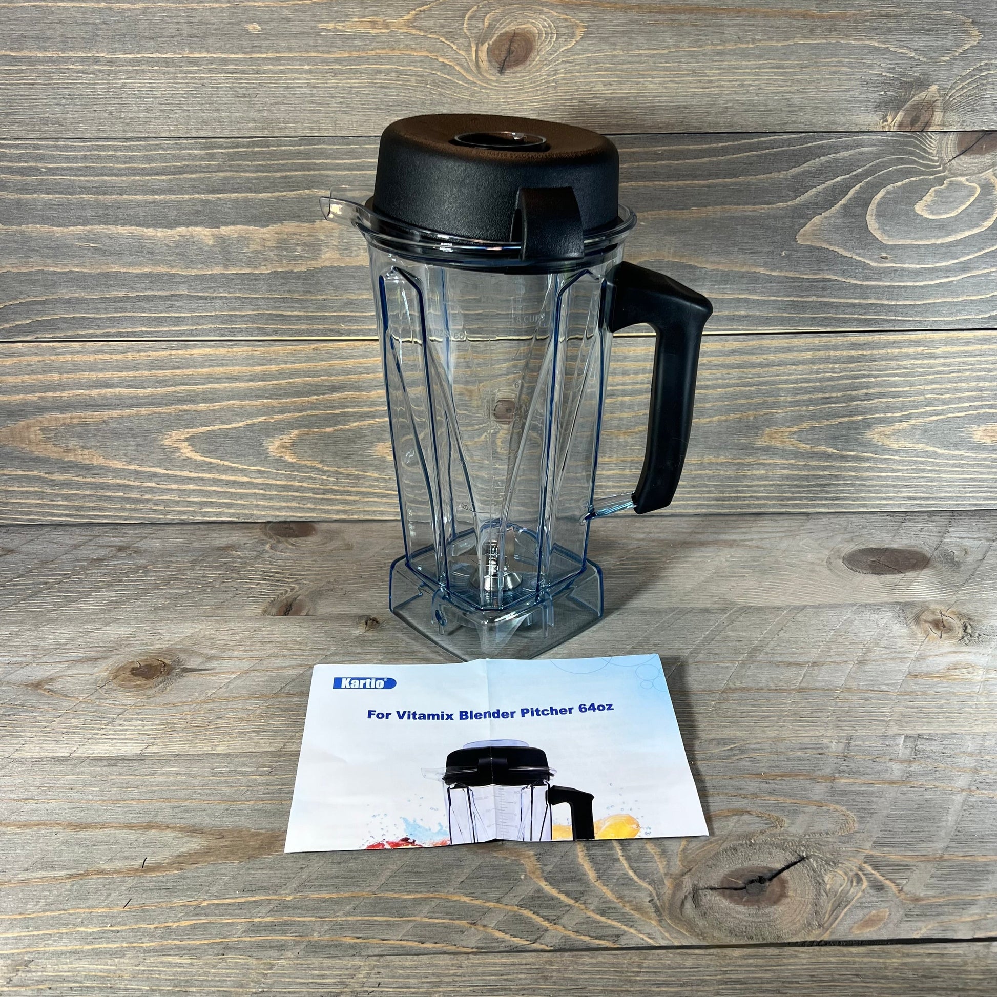 64oz replacement blender pitcher for Vitamix models, shown with black lid on a wooden surface.