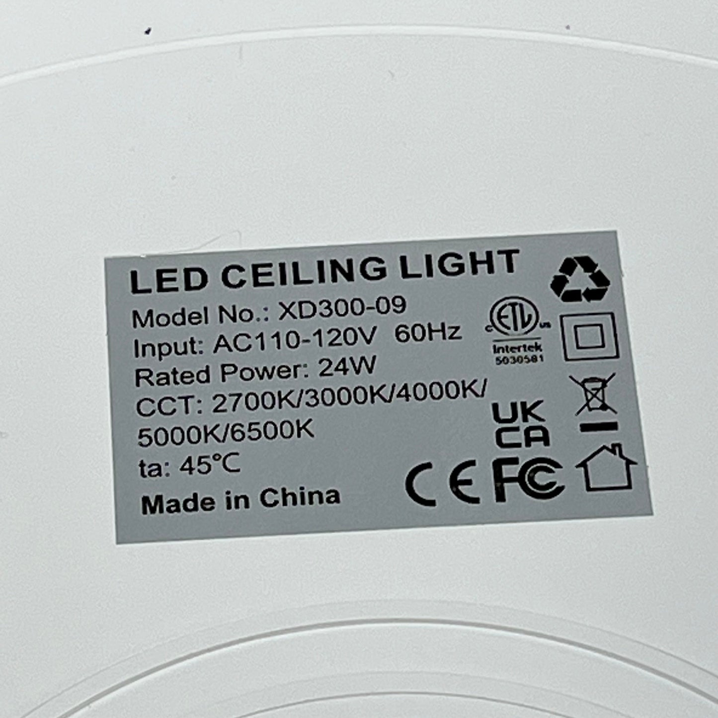 LED ceiling light model XD300-09 label showing specifications, including 24W power and 2700K-6500K color range.
