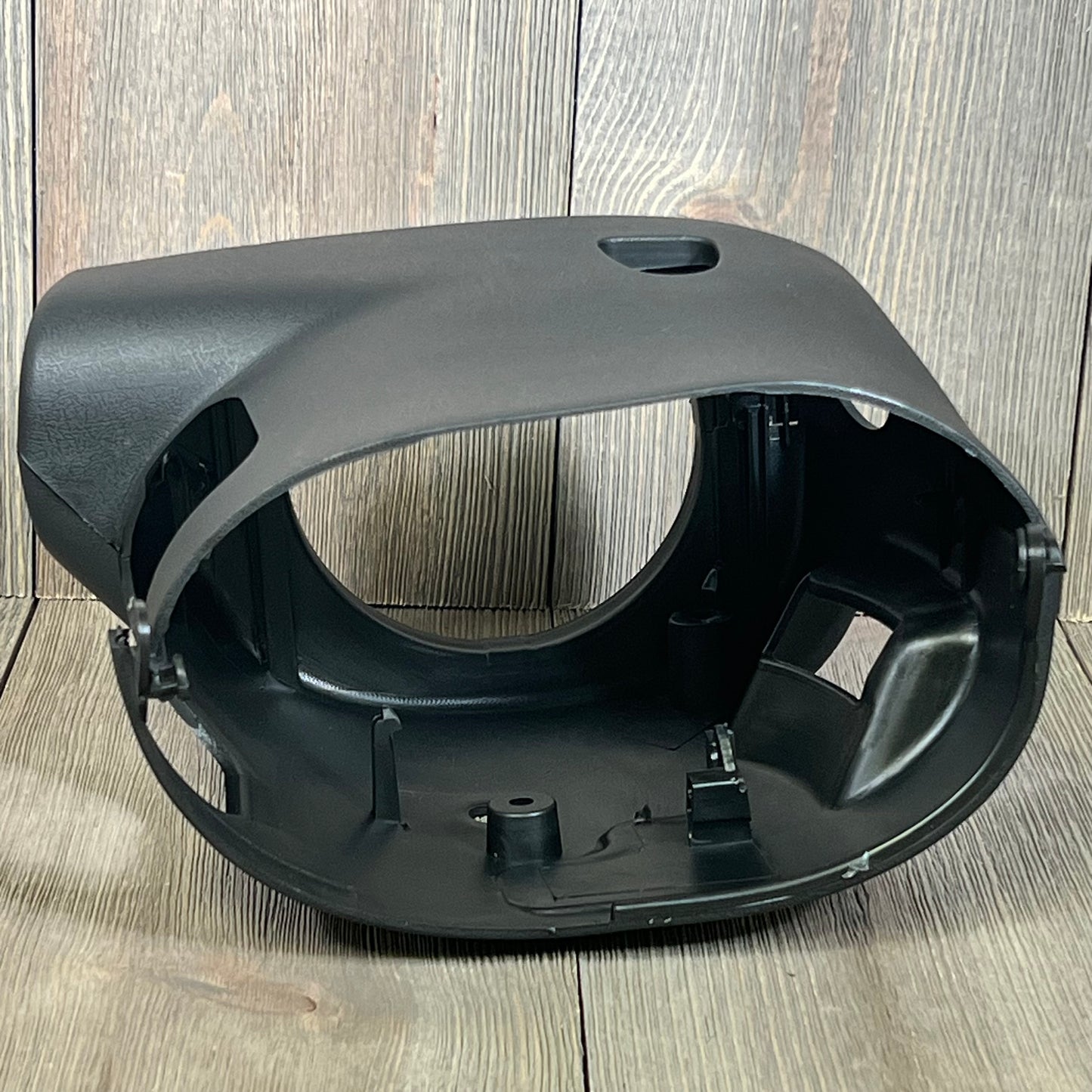 Black LOSTAR steering column cover shroud for 2003-2006 Chevy/GMC, shown on a wooden surface.