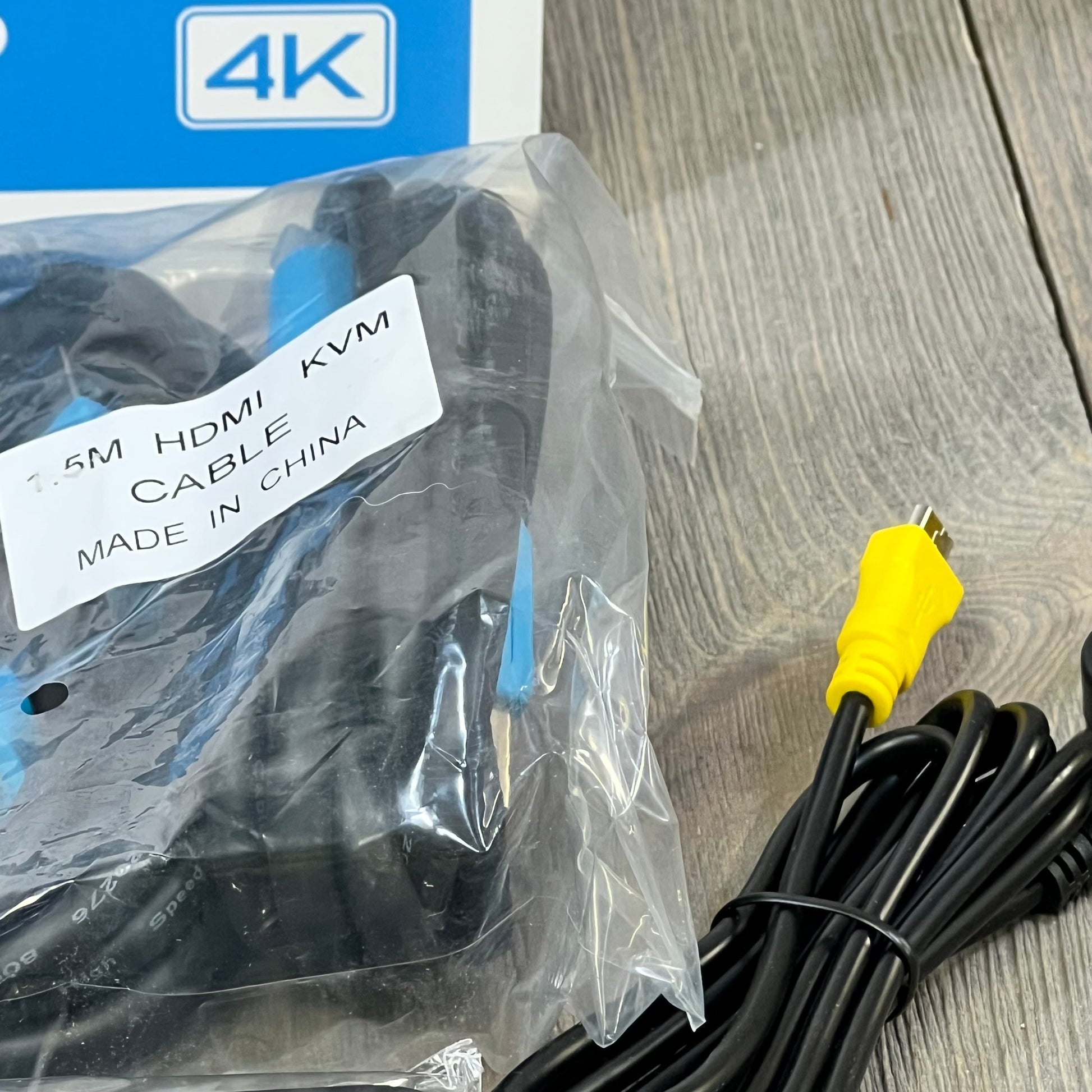1.5m HDMI KVM cable set for 4K HDMI KVM Switch, displaying cables and packaging on a wooden surface.