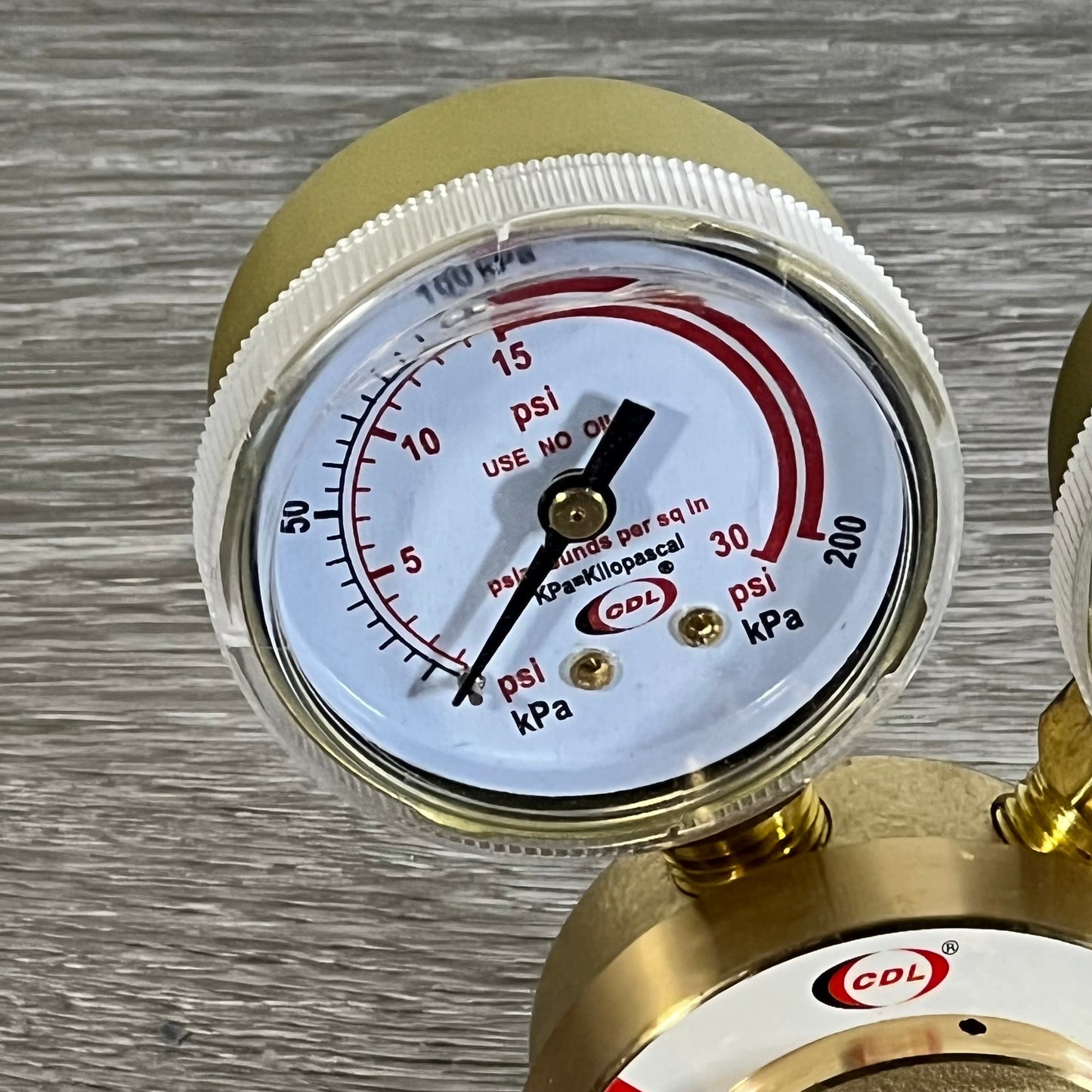 Close-up of LX65/88 Acetylene Regulator showing dual gauge display with psi and kPa readings.