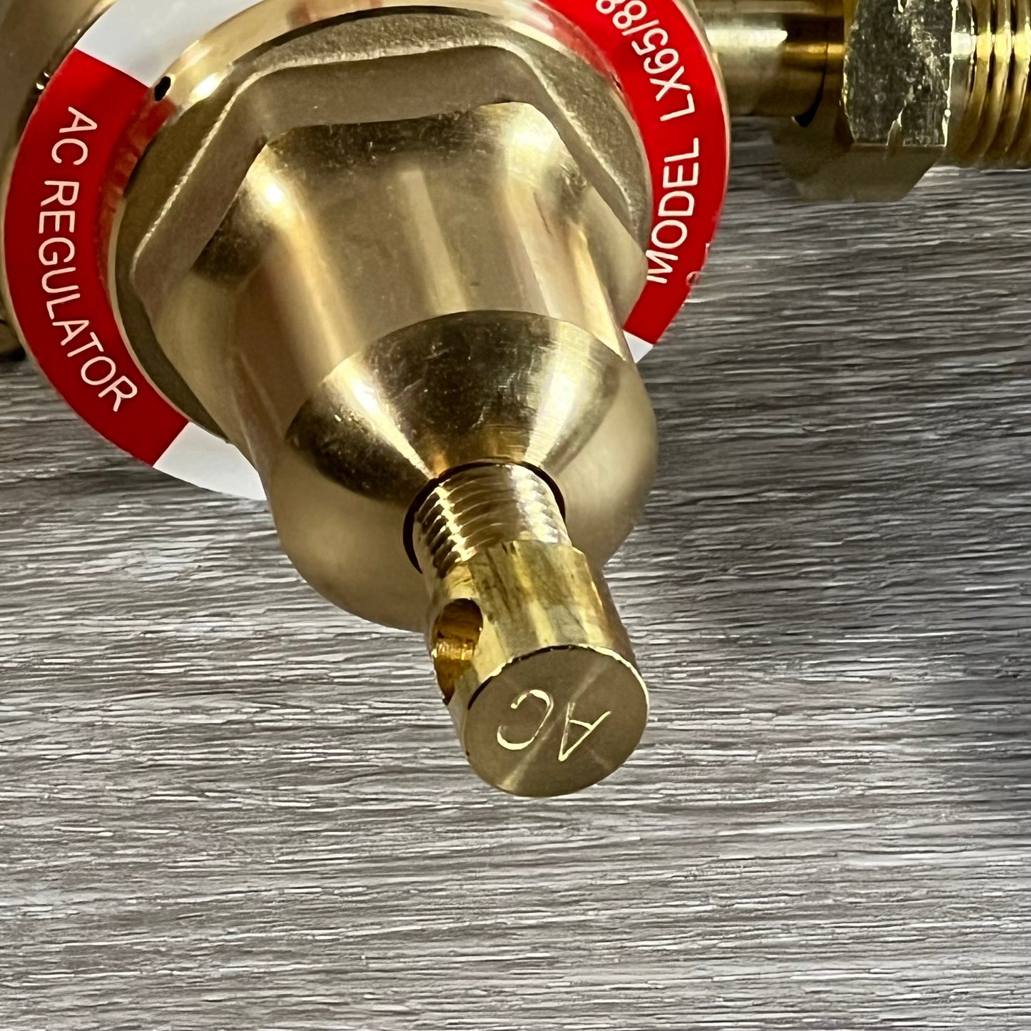 Close-up of the LX65/88 acetylene regulator showing the CGA510 connection and detailed brass components.