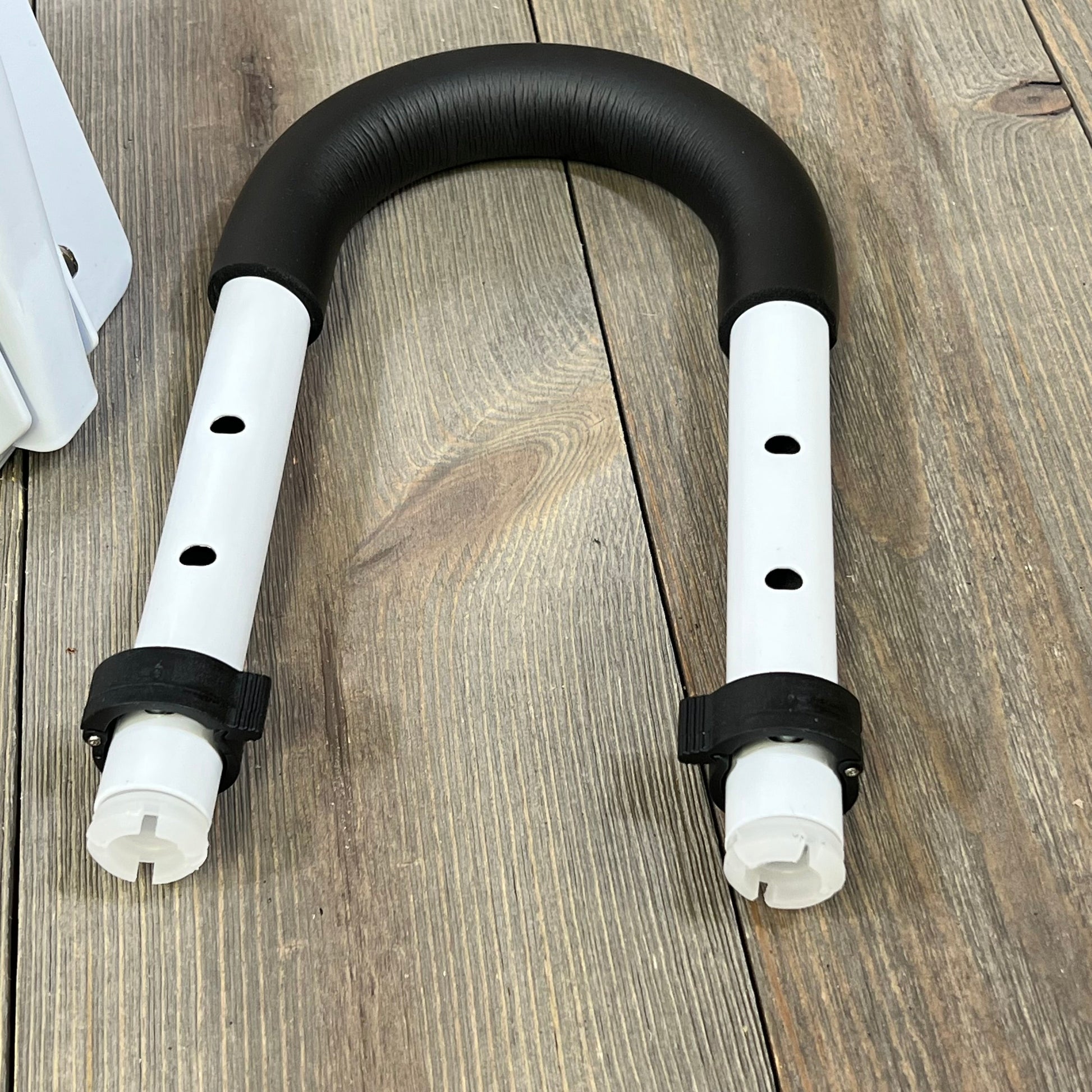 Adjustable Vaunn Medical bathtub handle grab bar with black grip and white frame, ideal for senior safety.