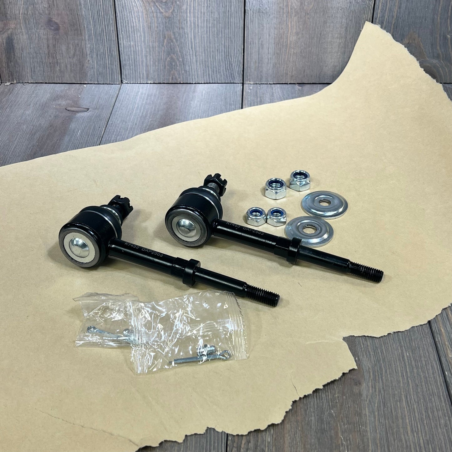 Front sway bar links and hardware for Dodge Ram 1500, 2500, 3500 4WD, model years 2000-2002, on a wooden surface.