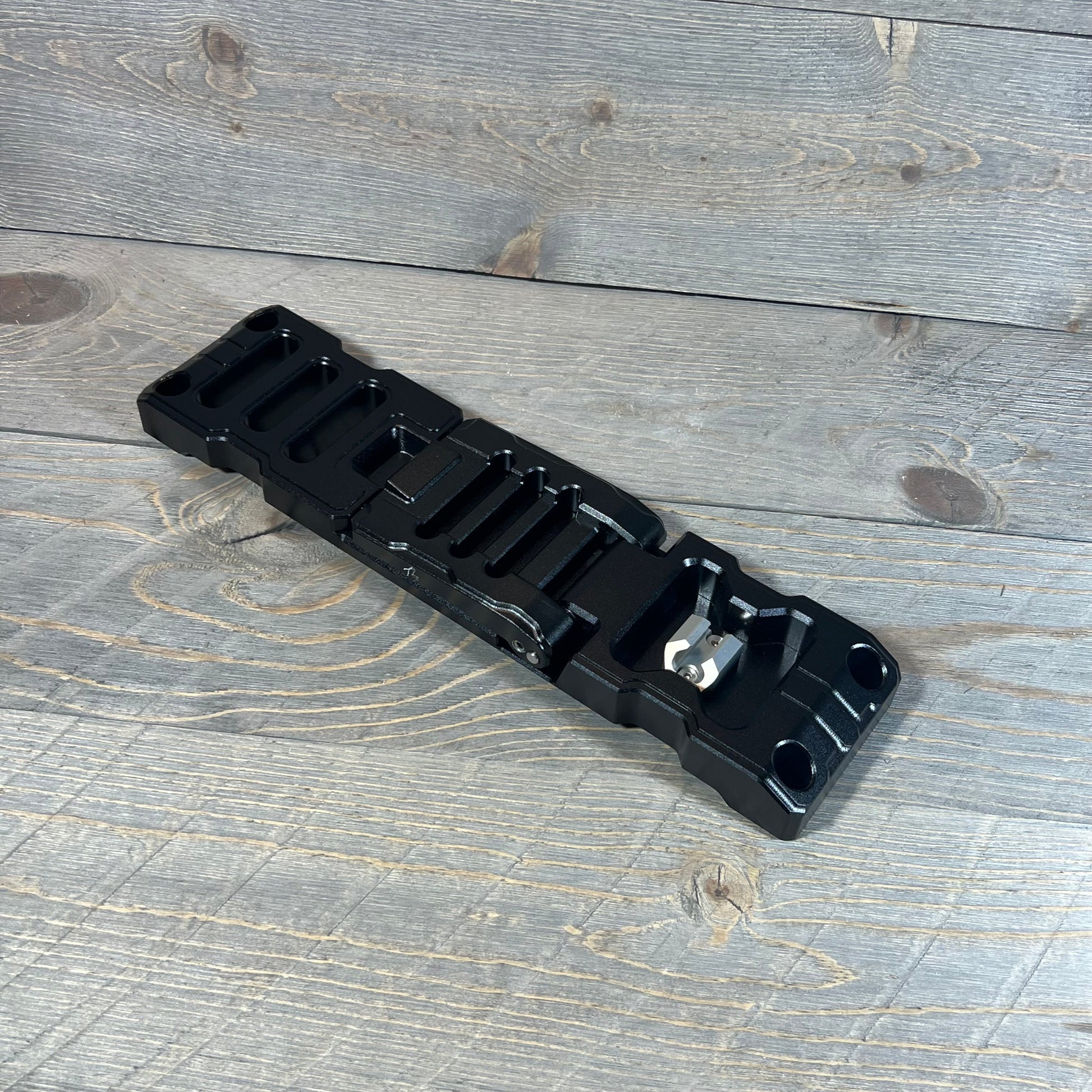 Aluminum alloy door hinge step for Jeep Wrangler & Gladiator, showcasing durable black finish on wooden background.
