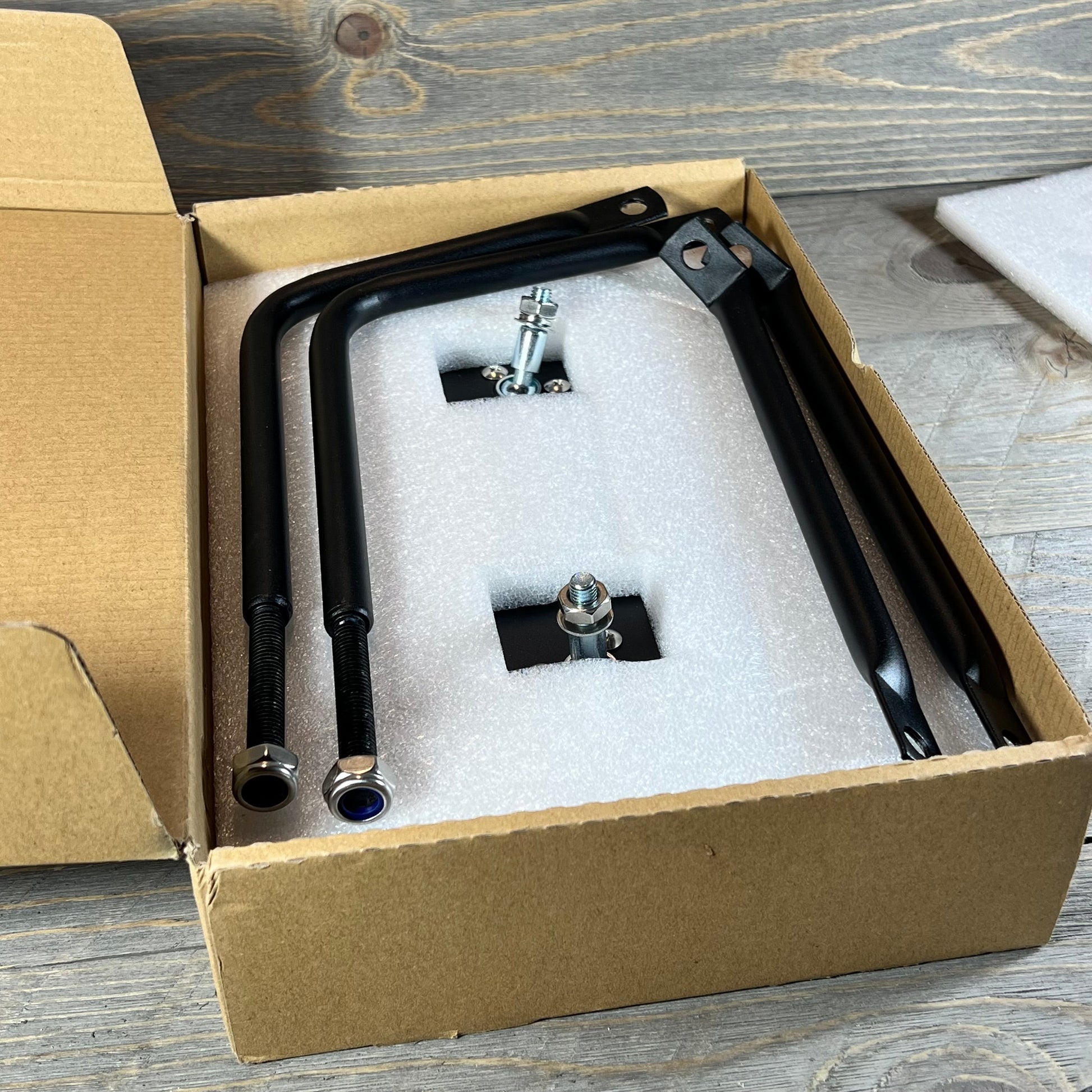 Anti-shake door mirrors for Jeep Wrangler in protective packaging, ready for installation.