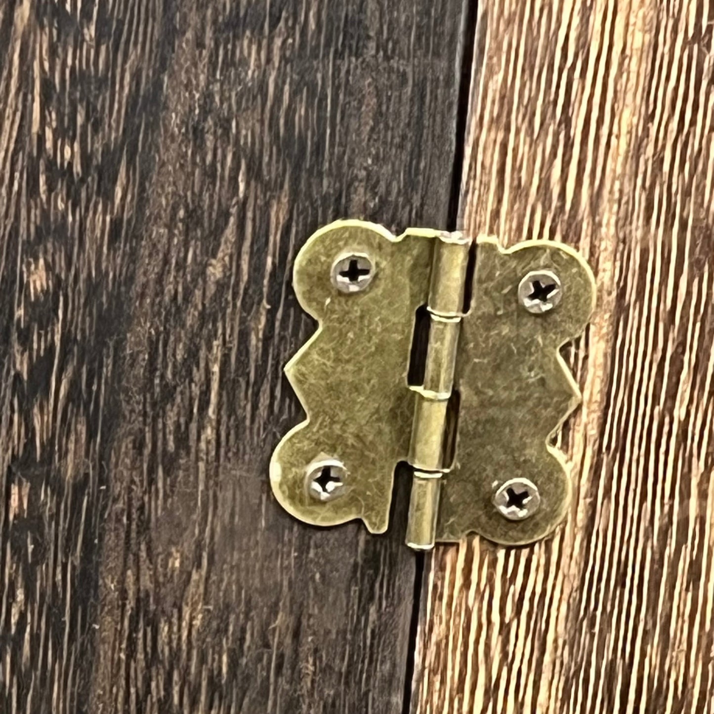 Close-up of brass hinge on GLANT Wooden Barn Door Jewelry Organizer, emphasizing rustic craftsmanship.