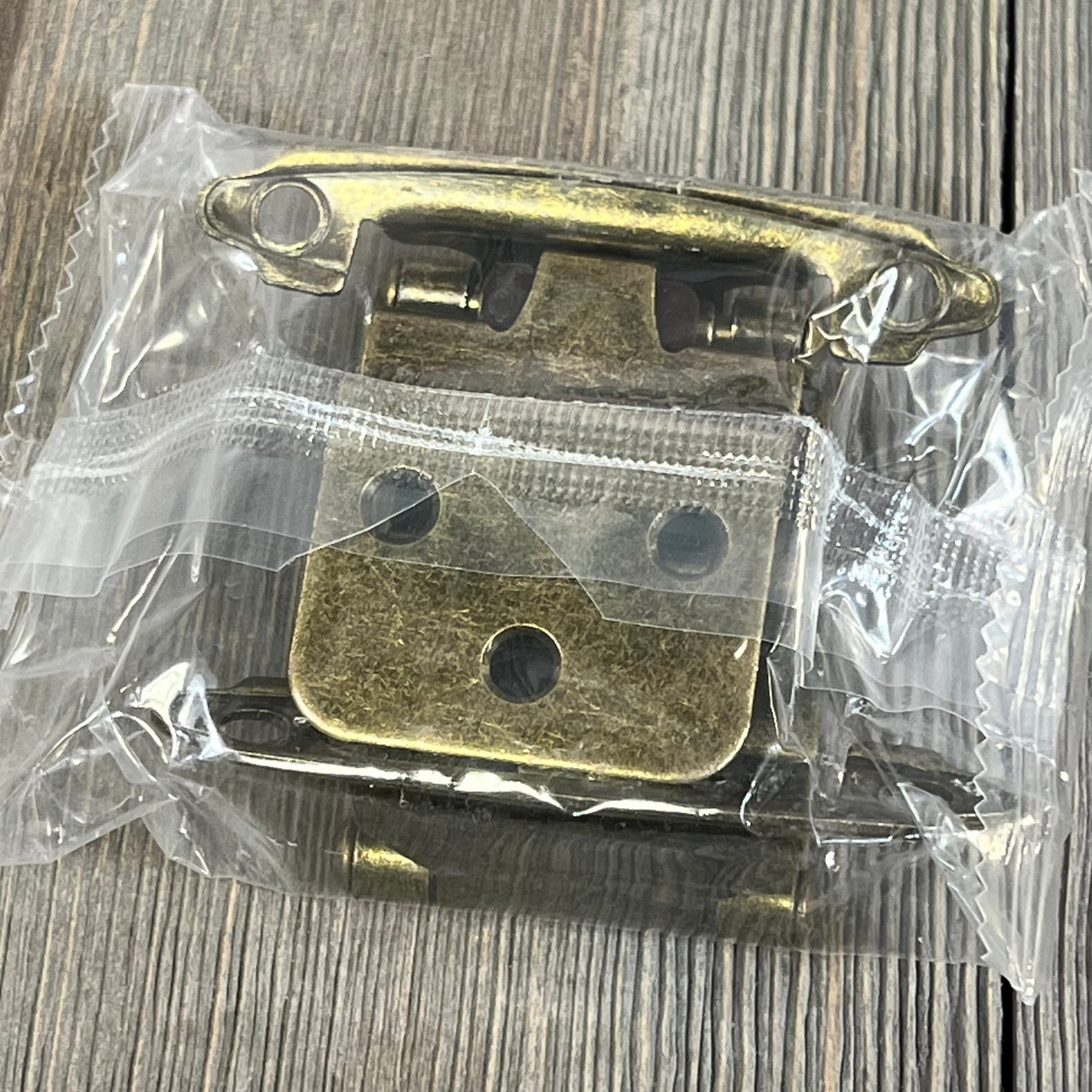 Antique brass inset cabinet door hinges in clear packaging, showcasing durable construction for kitchen cabinets.