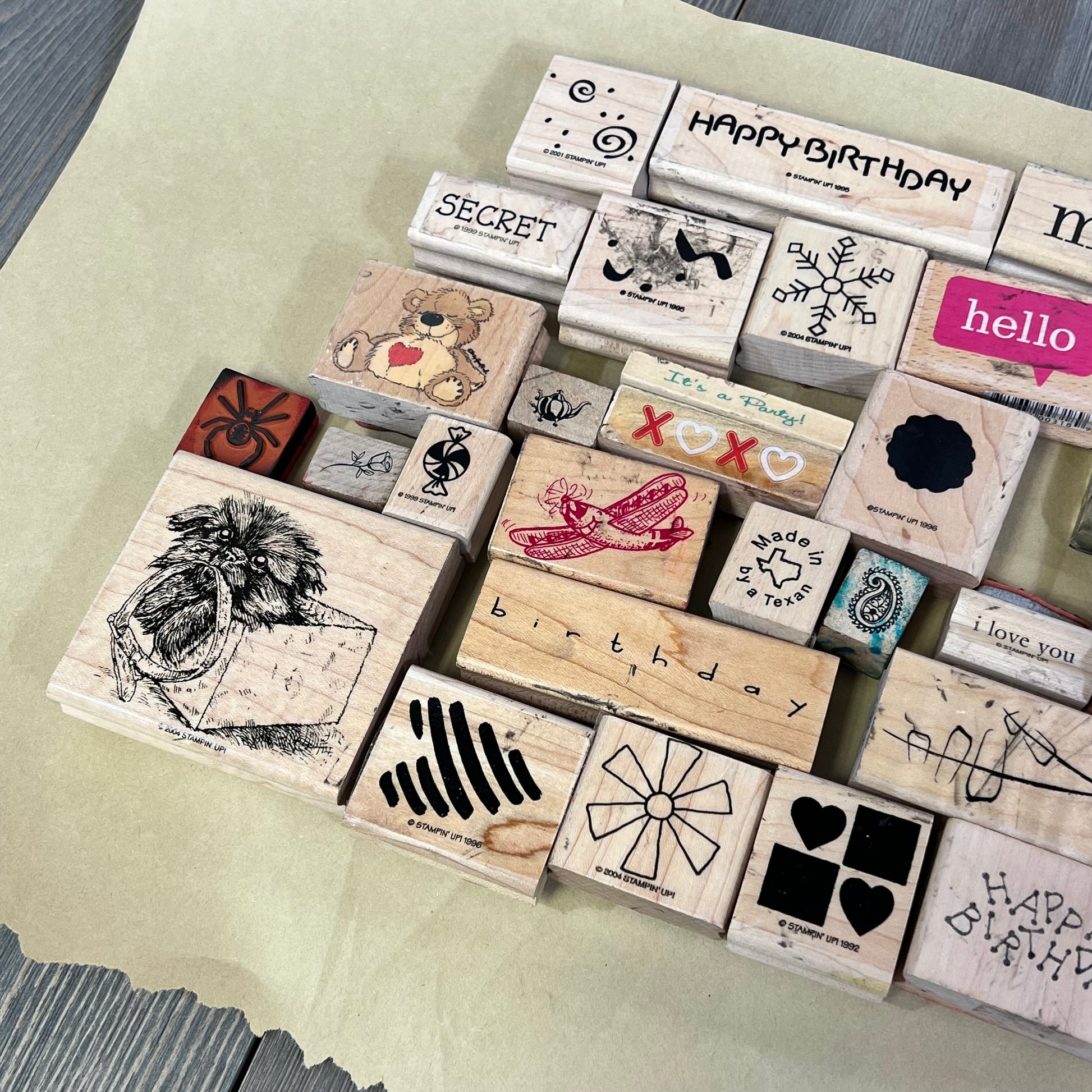 Collection of 33 unique rubber ink stamps on wood blocks, featuring diverse designs for crafting and decoration.