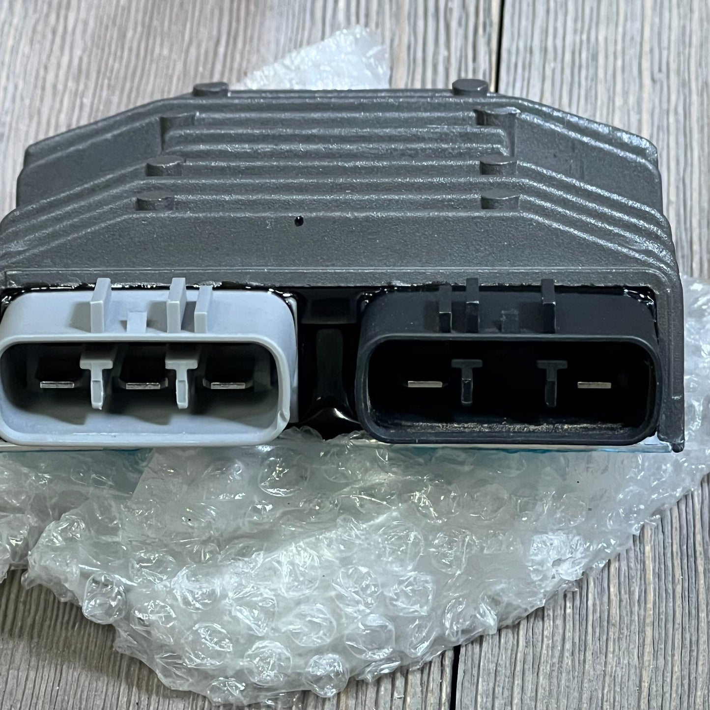 Yamaha voltage regulator rectifier for Grizzly, Rhino, Viking, and Kodiak models on bubble wrap packaging.