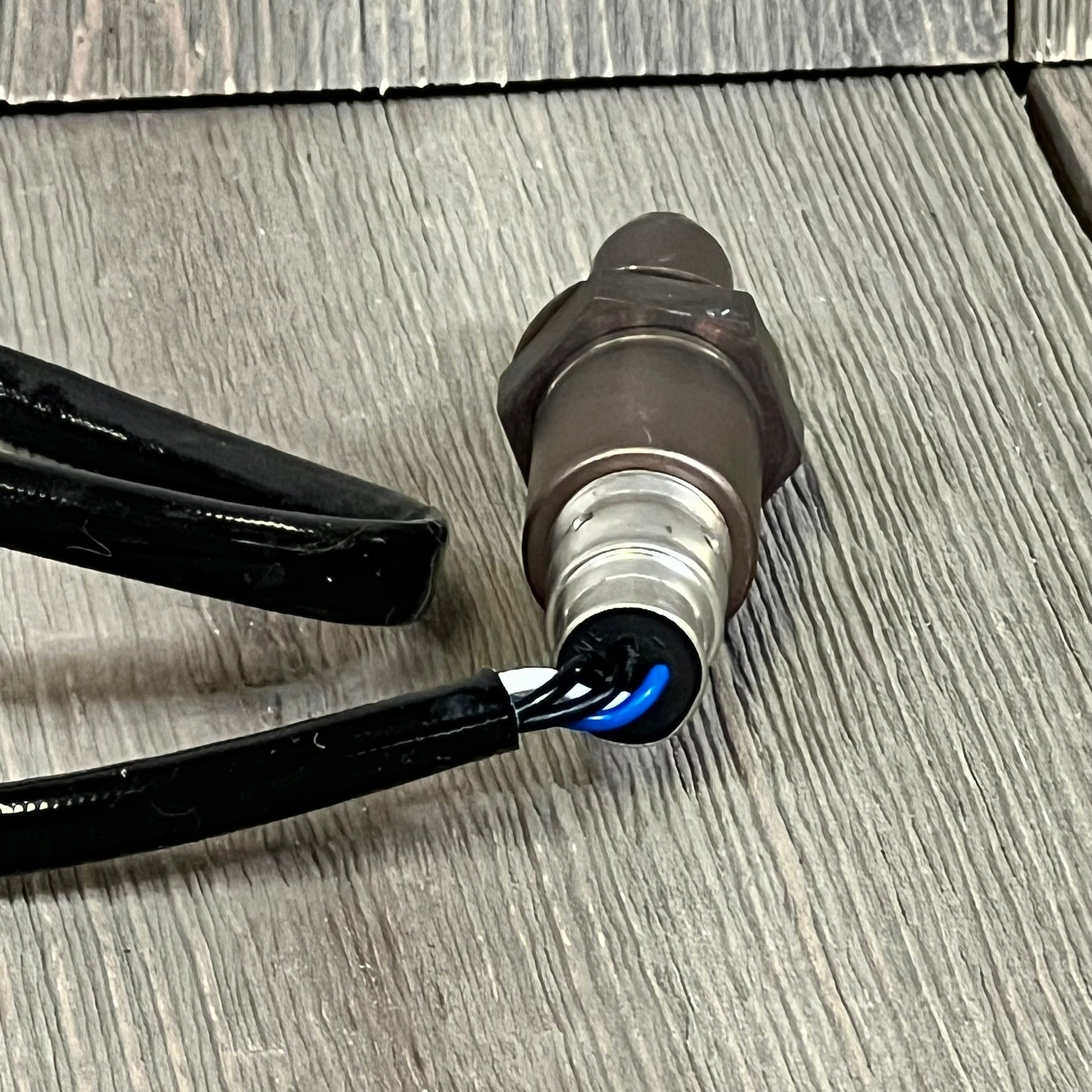 Upstream O2 sensor by BDFHYK for Lexus and Toyota, model 1047104268, shown on a wooden surface.