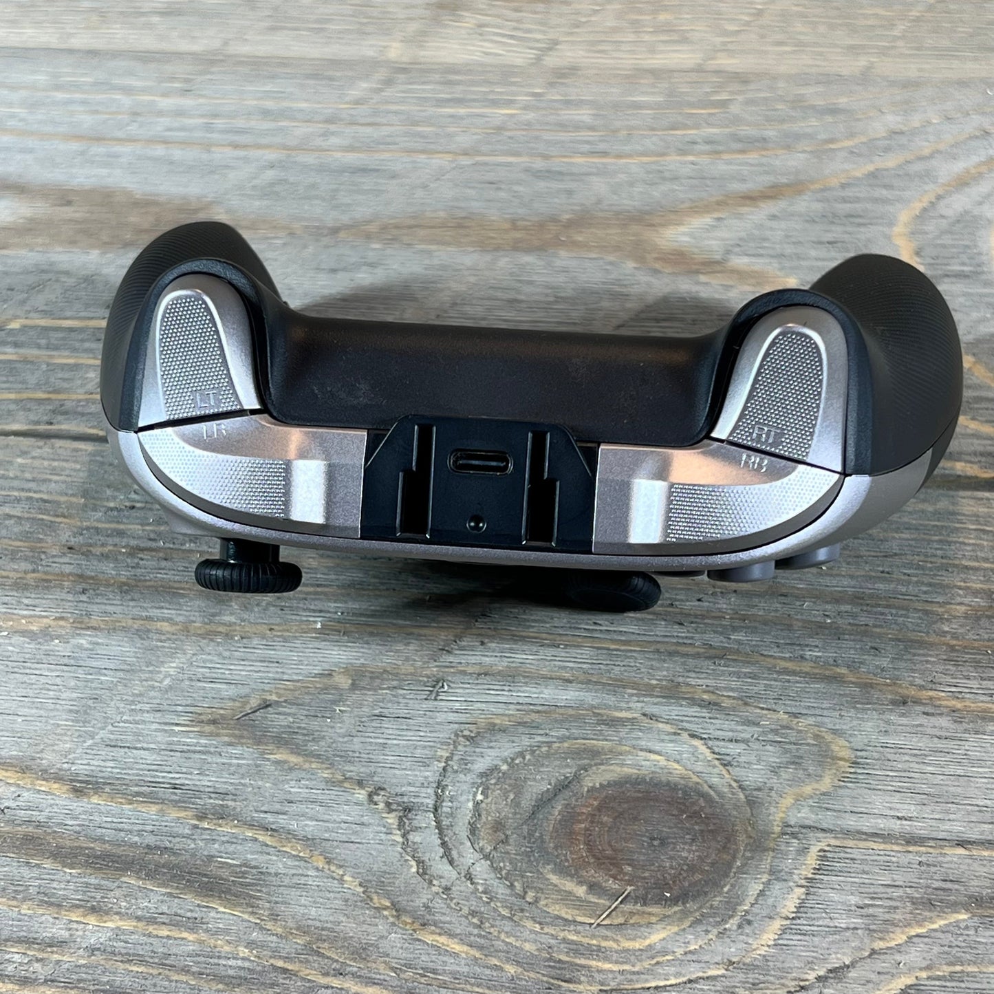 Back view of EasySMX X10 Wireless Bluetooth Controller, showing trigger buttons and USB charging port.