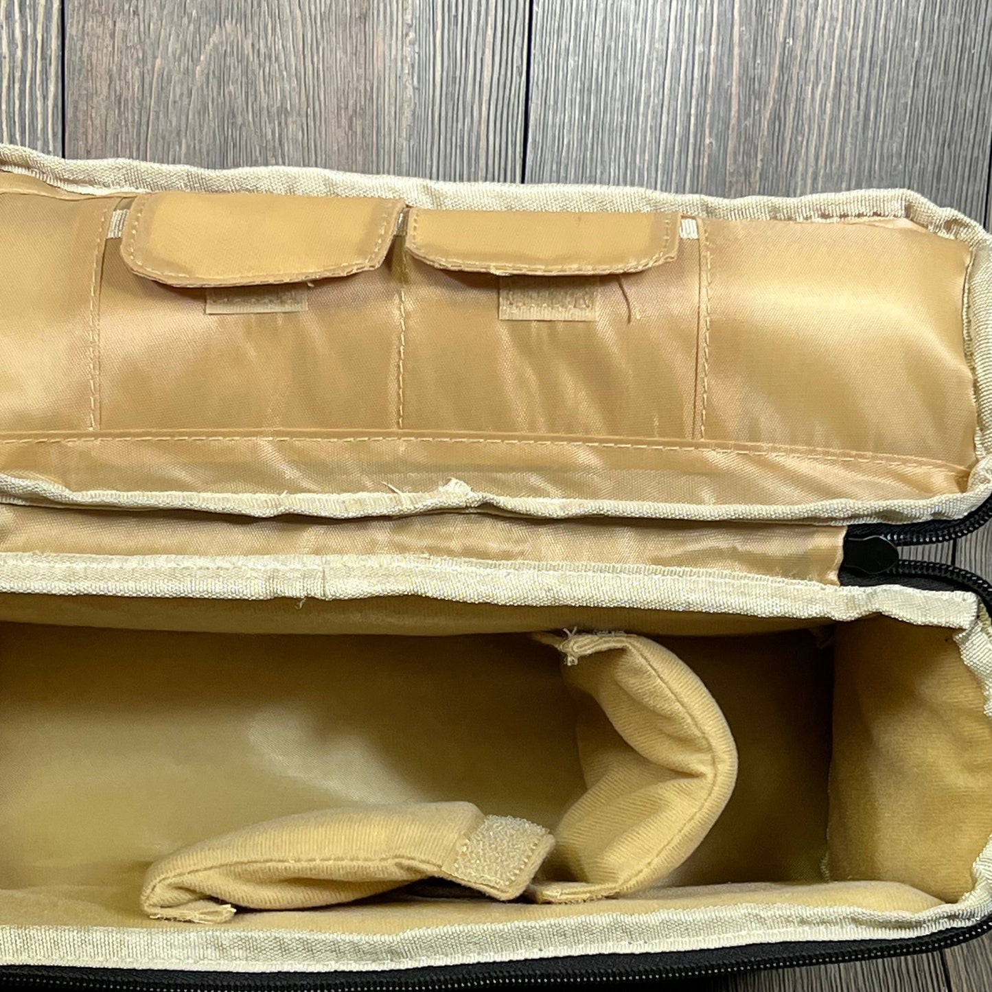 Beige camera insert bag divider with padded compartments and handle, ideal for organizing DSLR gear in backpacks.