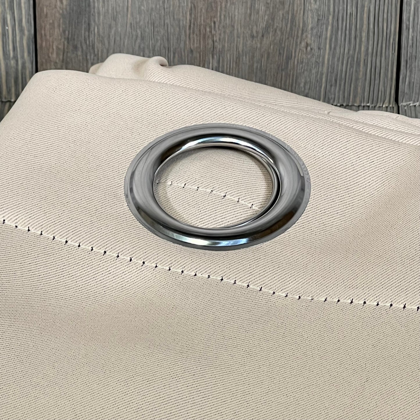 Beige ChrisDowa blackout curtain with silver grommet, showcasing thick fabric for bedroom light blocking.