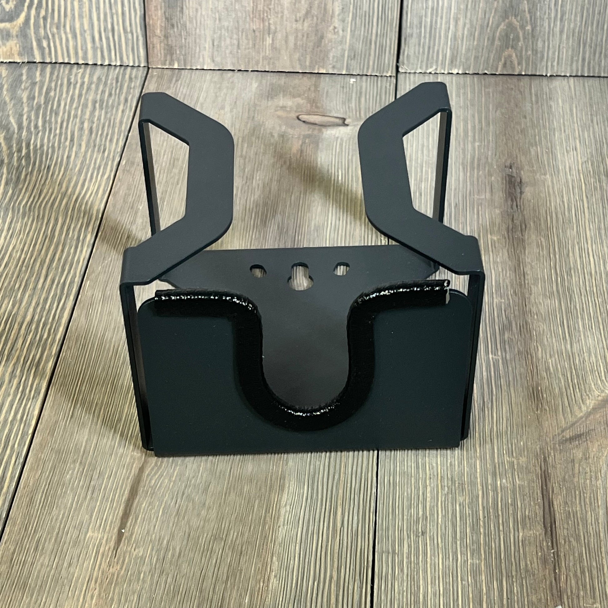 Wall-mounted black metal EV charger holder with J-Hook for organizing SAE J1772 cables efficiently.