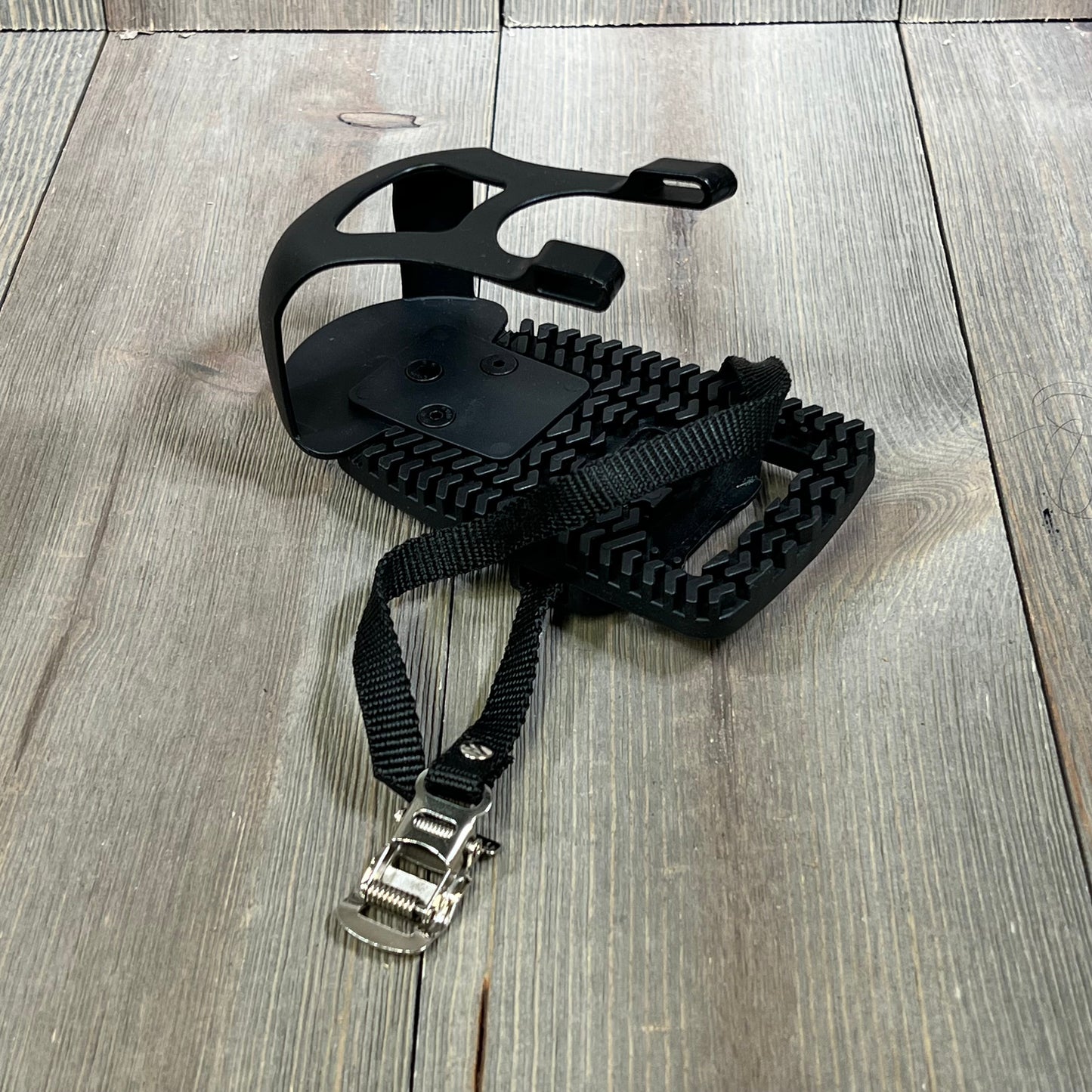 Black Kelecuia toe cage adapter for Peloton bike, featuring durable straps and sturdy design for sneaker compatibility.