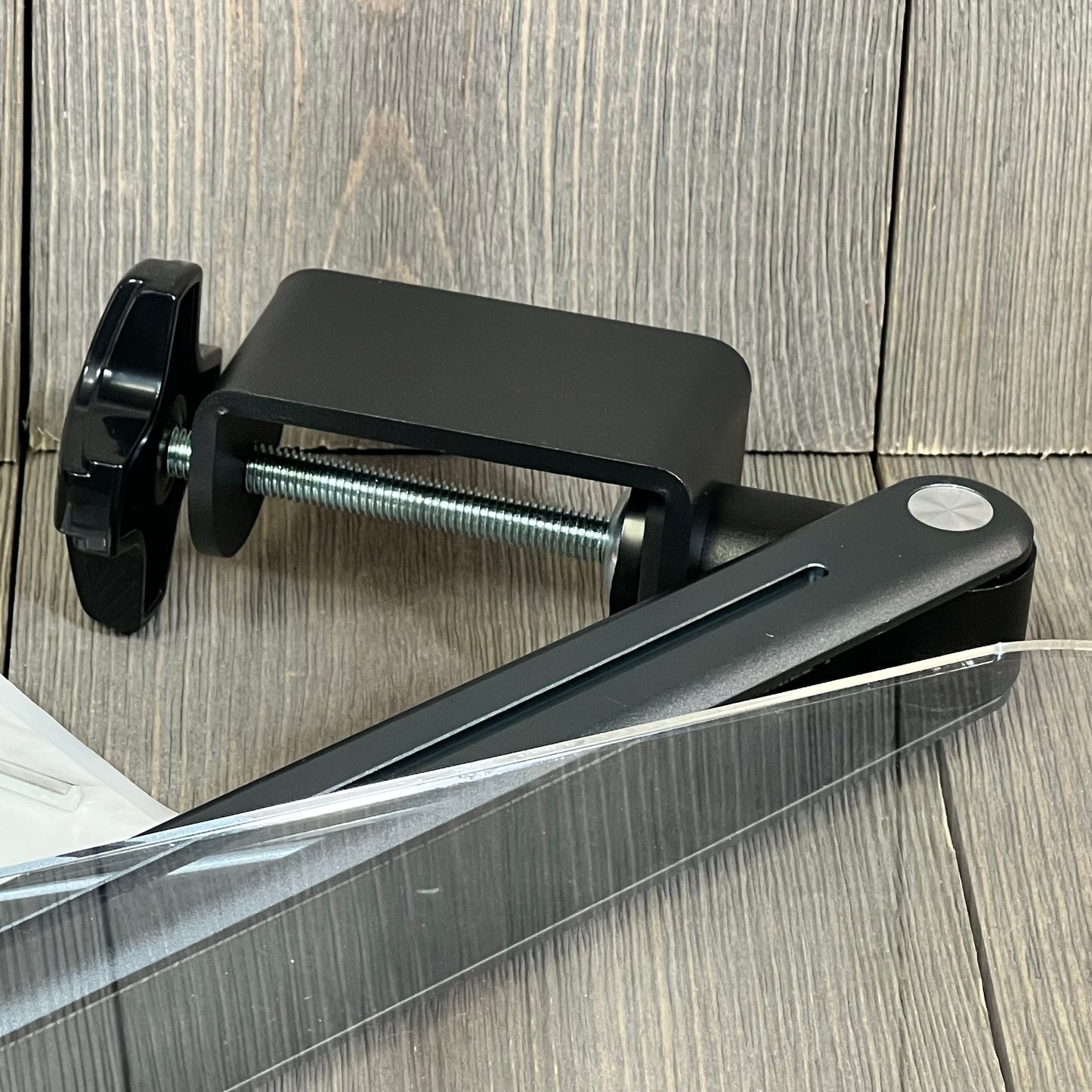 Gray desk clamp acrylic book stand showcasing ergonomic design and adjustable height, ideal for reading and displaying tablets.