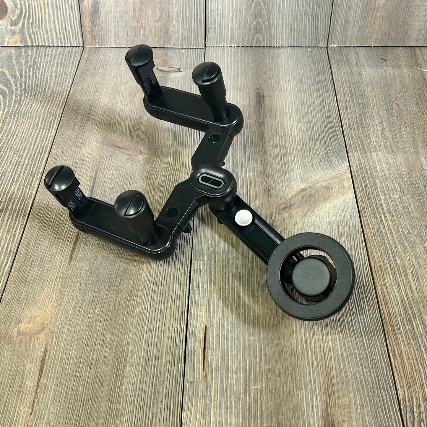 Magsafe car mount with rotatable design, shown on a wooden surface, compatible with iPhone and metal ring cases.