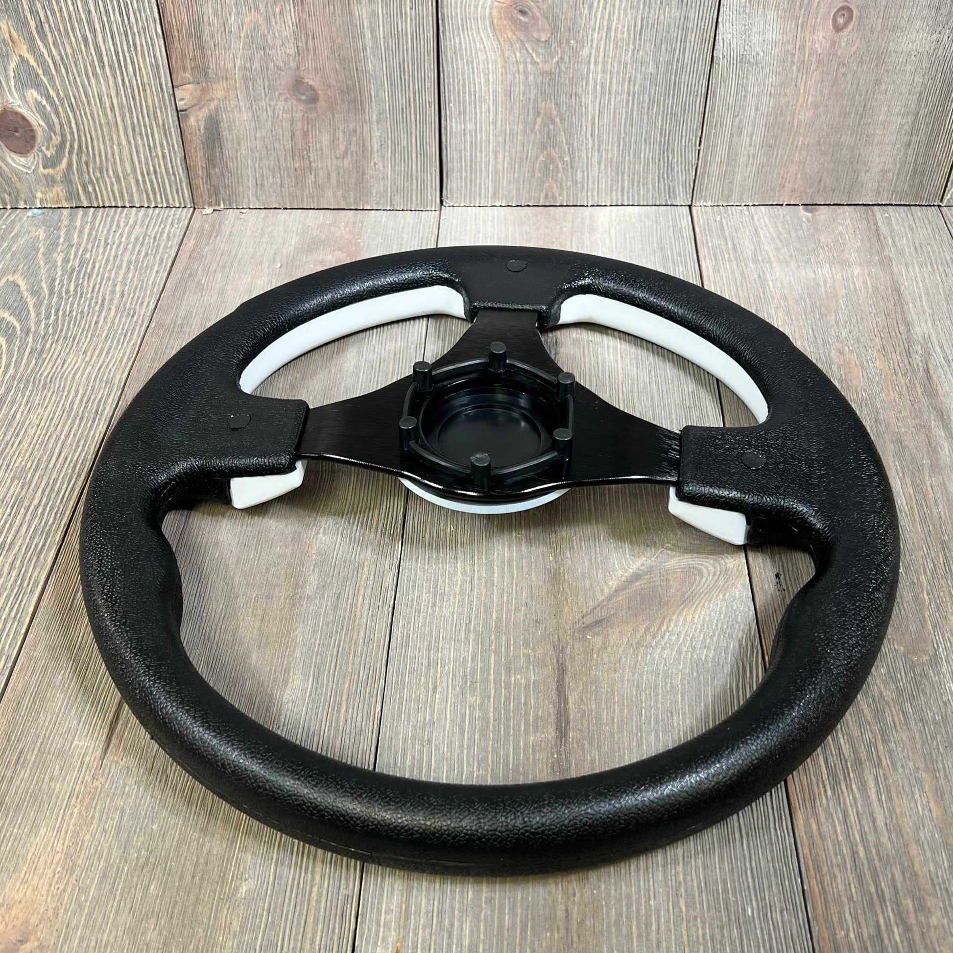 Durable 12.5-inch black boat steering wheel with anti-slip grip, ideal for yachts and pontoon boats, featuring a 3/4" axle adapter.