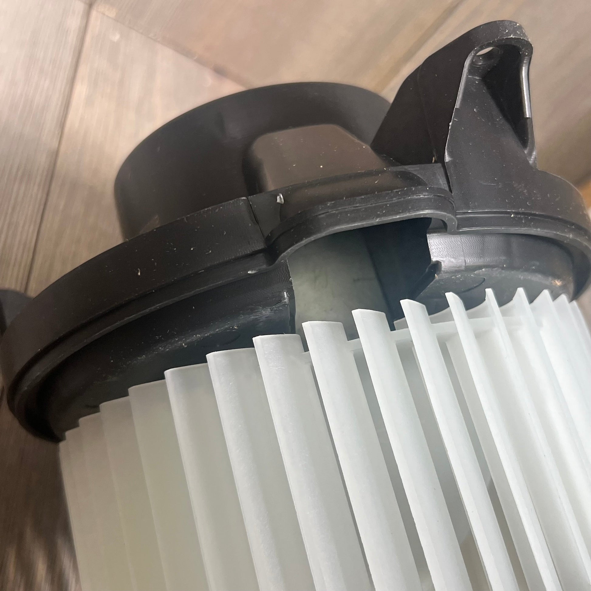 Close-up view of A/C heater blower motor for Nissan Frontier, Pathfinder, Xterra, showcasing intricate fan blade design.