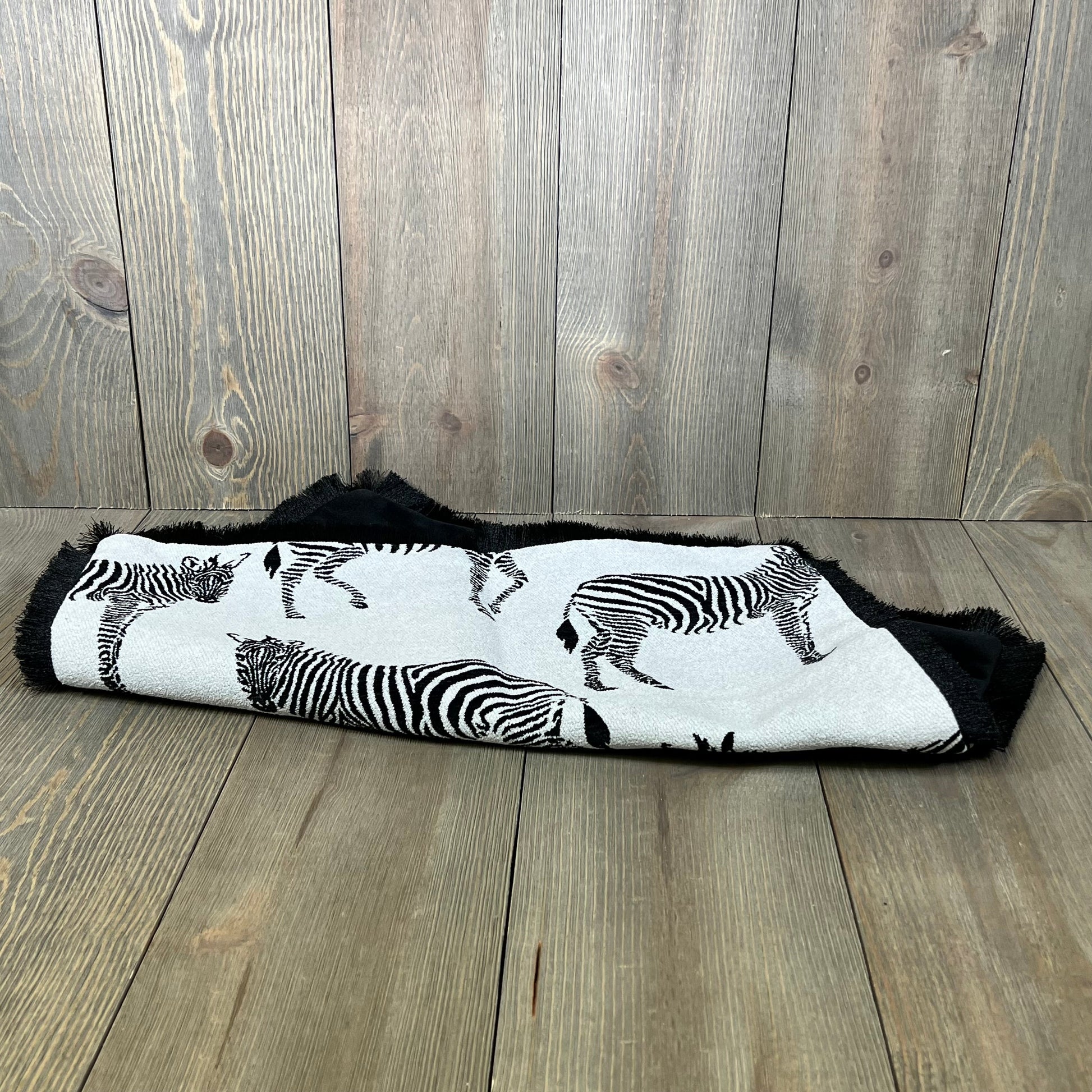 Luxury modern zebra pattern cushion cover, folded on a wooden surface, perfect for living room or bedroom decor.