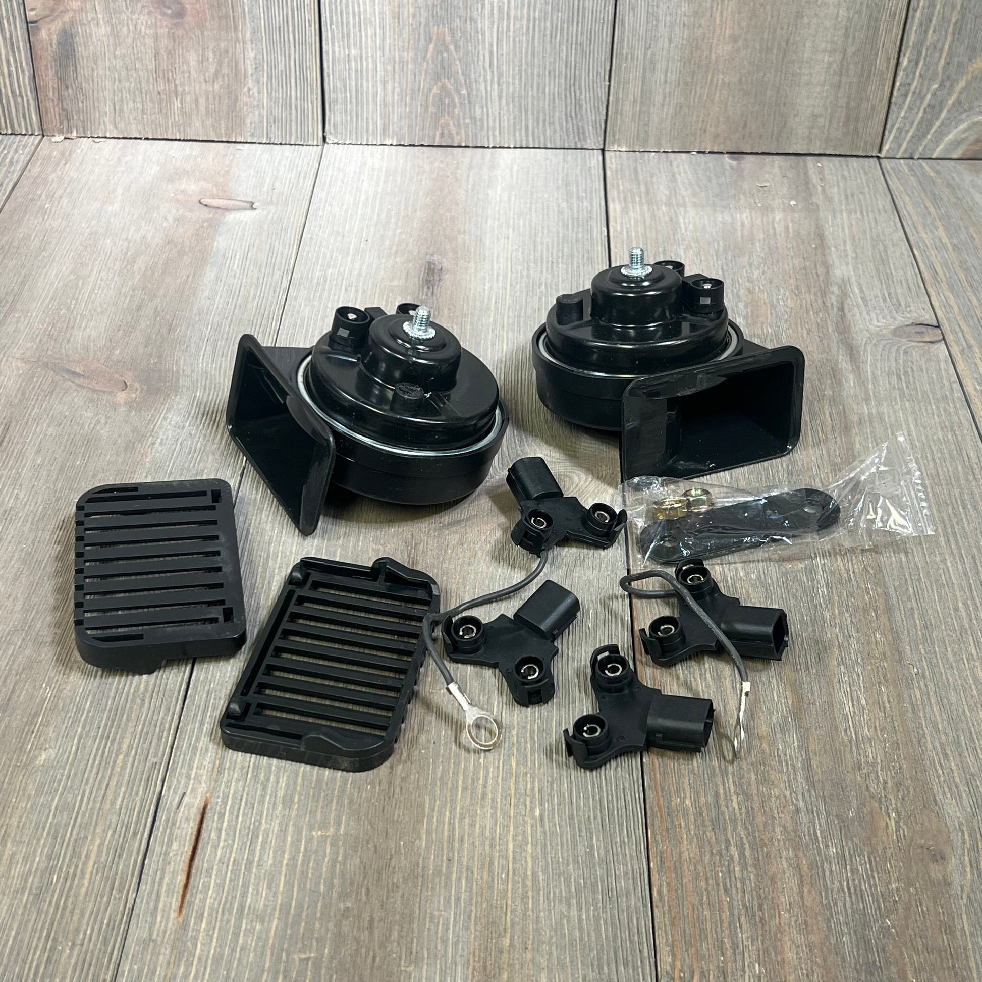 Loud dual-tone car horn set for Honda Civic CRV Odyssey, includes components and accessories on wooden background.