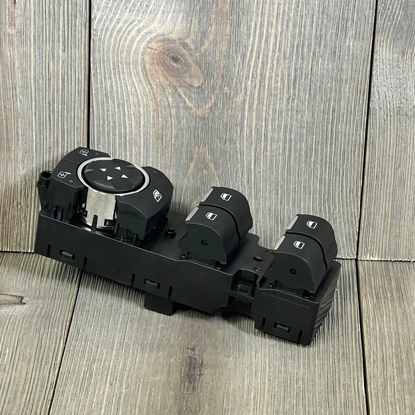 Black Motoforti power window switch for Ford Edge and F-150, featuring multiple control buttons on a wooden background.