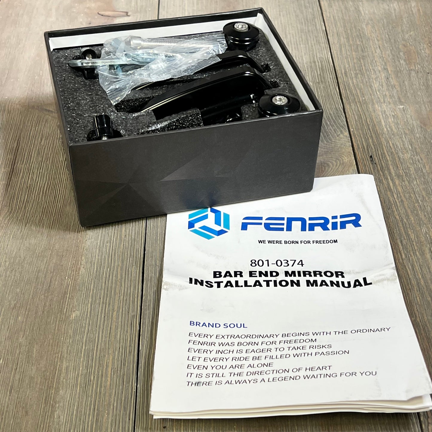 FENRIR CNC Aluminum Bar End Mirrors in box with installation manual on wooden surface.