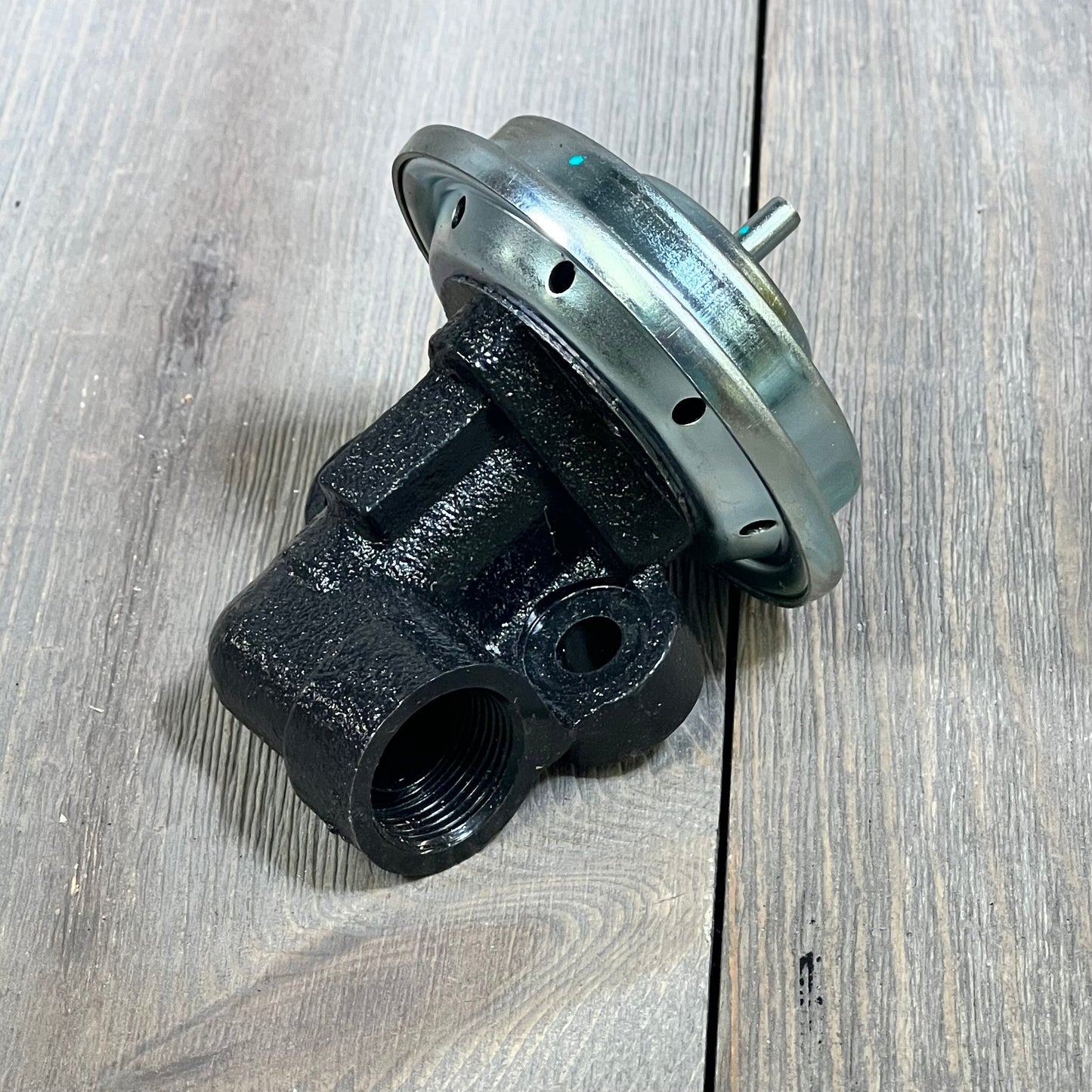 CARMOCAR EGR Valve EGV575 for Ford and Lincoln models, featuring durable construction on wood surface.