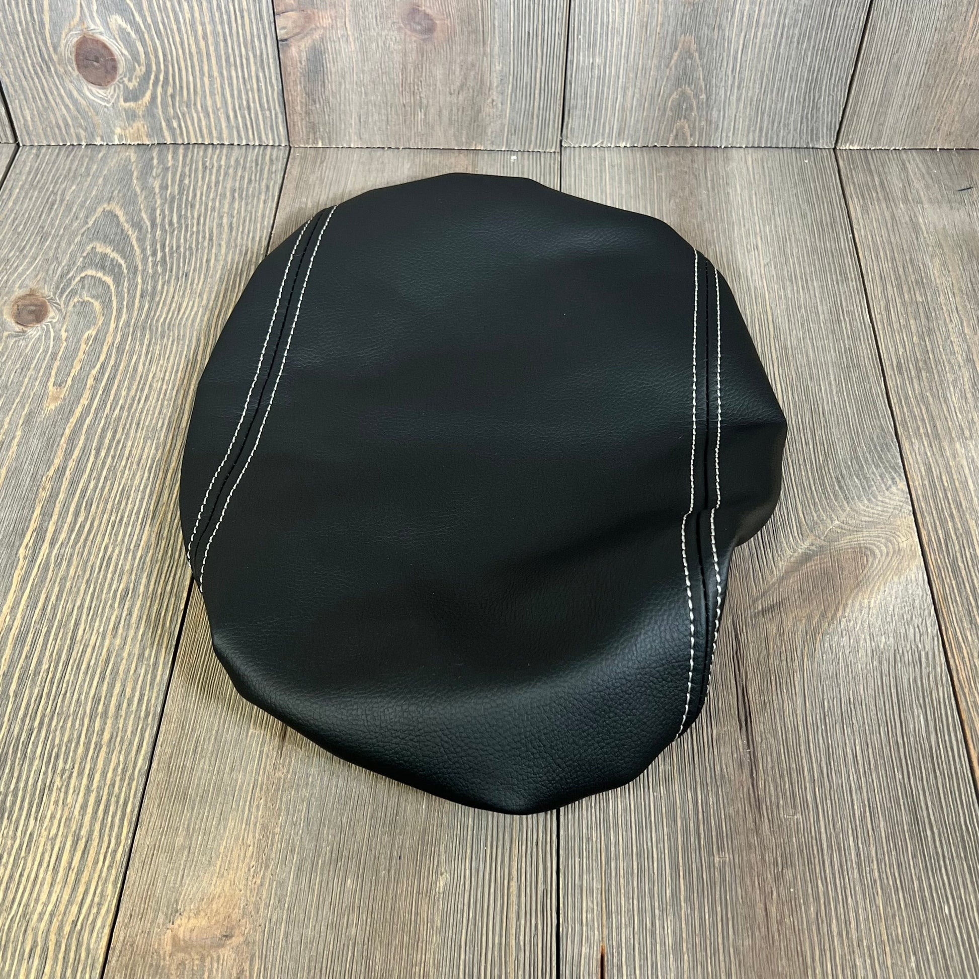 Black leather armrest cover with white stitching for Ford Explorer 2020-2025, enhancing car interior protection.