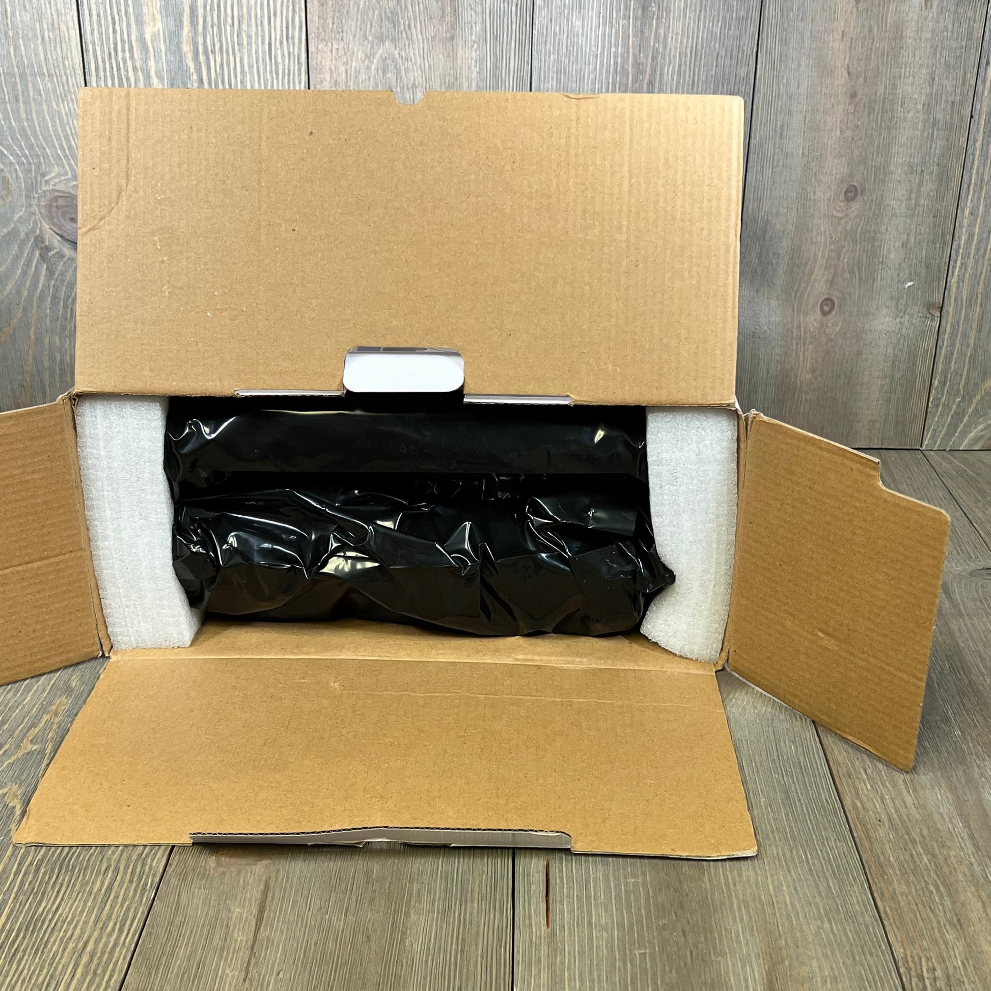 Open box revealing Compatible DR830 Drum 2 Pack for Brother printers, securely packaged in protective wrapping.