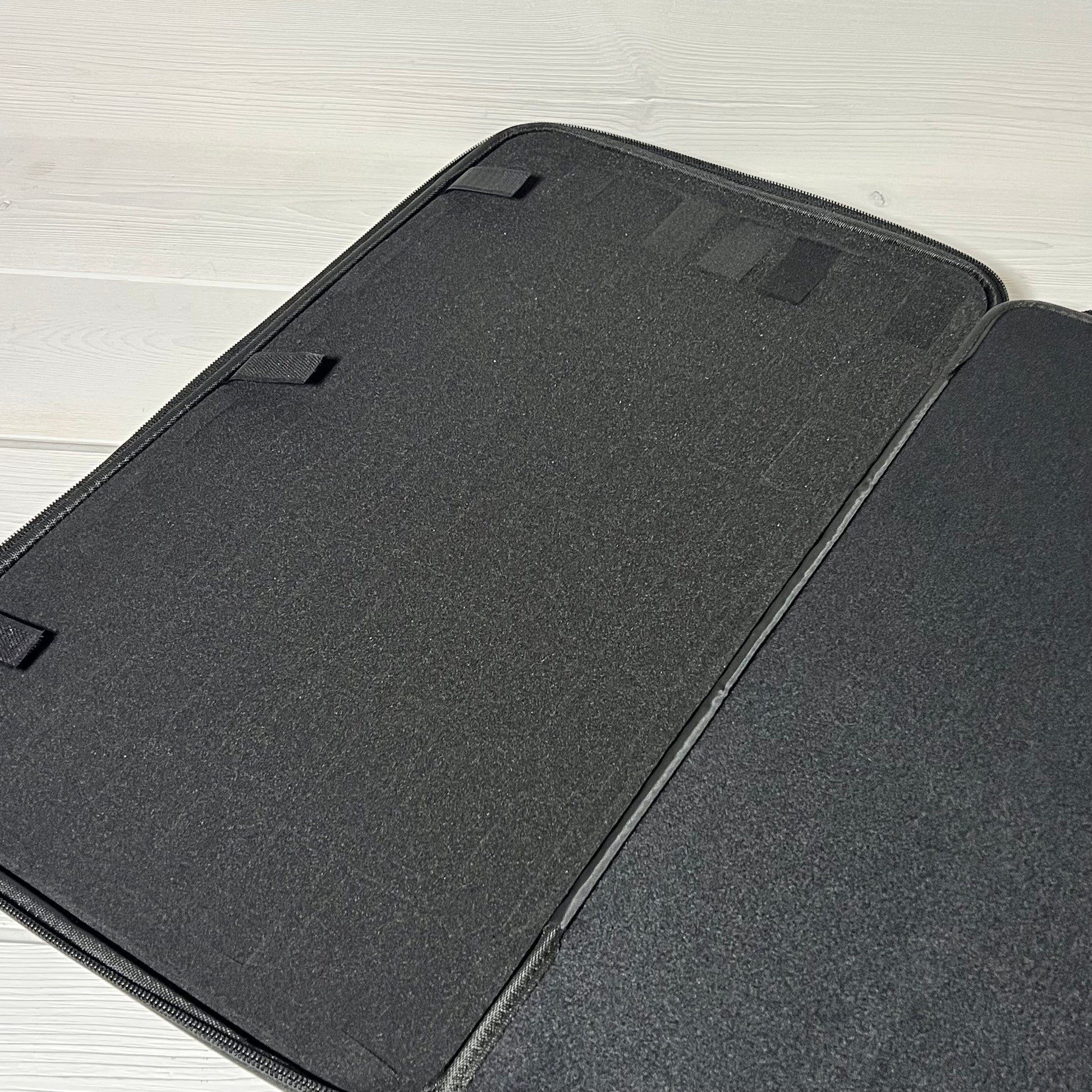 Black interior of Brappo miniature carrying case with customizable sponge slots for secure figure storage.