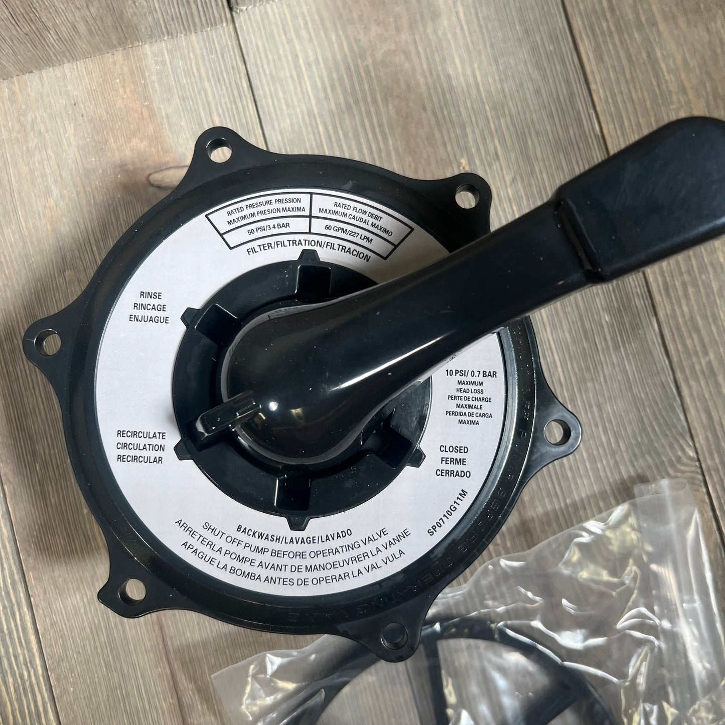 Black key cover and handle assembly for Hayward multiport valves, showcasing detailed labels and sturdy design.