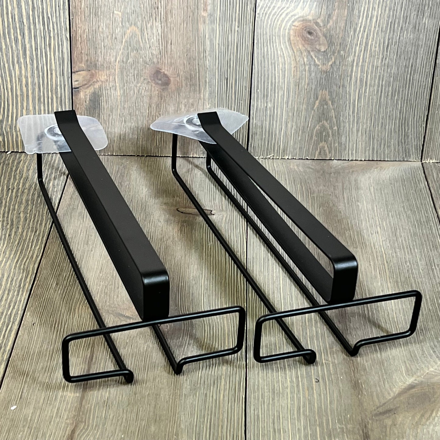 Black under-cabinet wine glass rack with two holders for stemware storage, ideal kitchen organizer for hanging wine glasses.