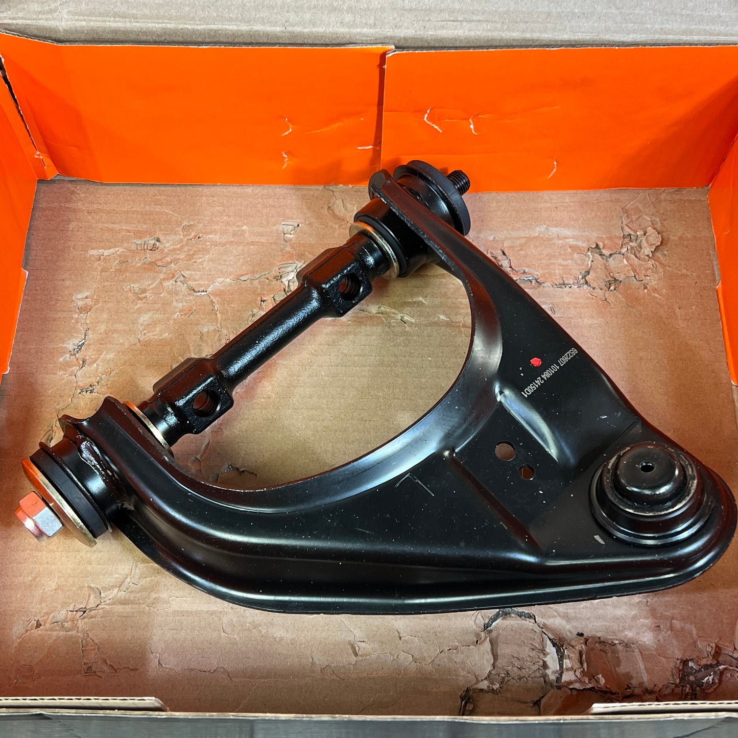 Front driver side upper control arm and ball joint assembly for Dodge/Mitsubishi, durable black finish.