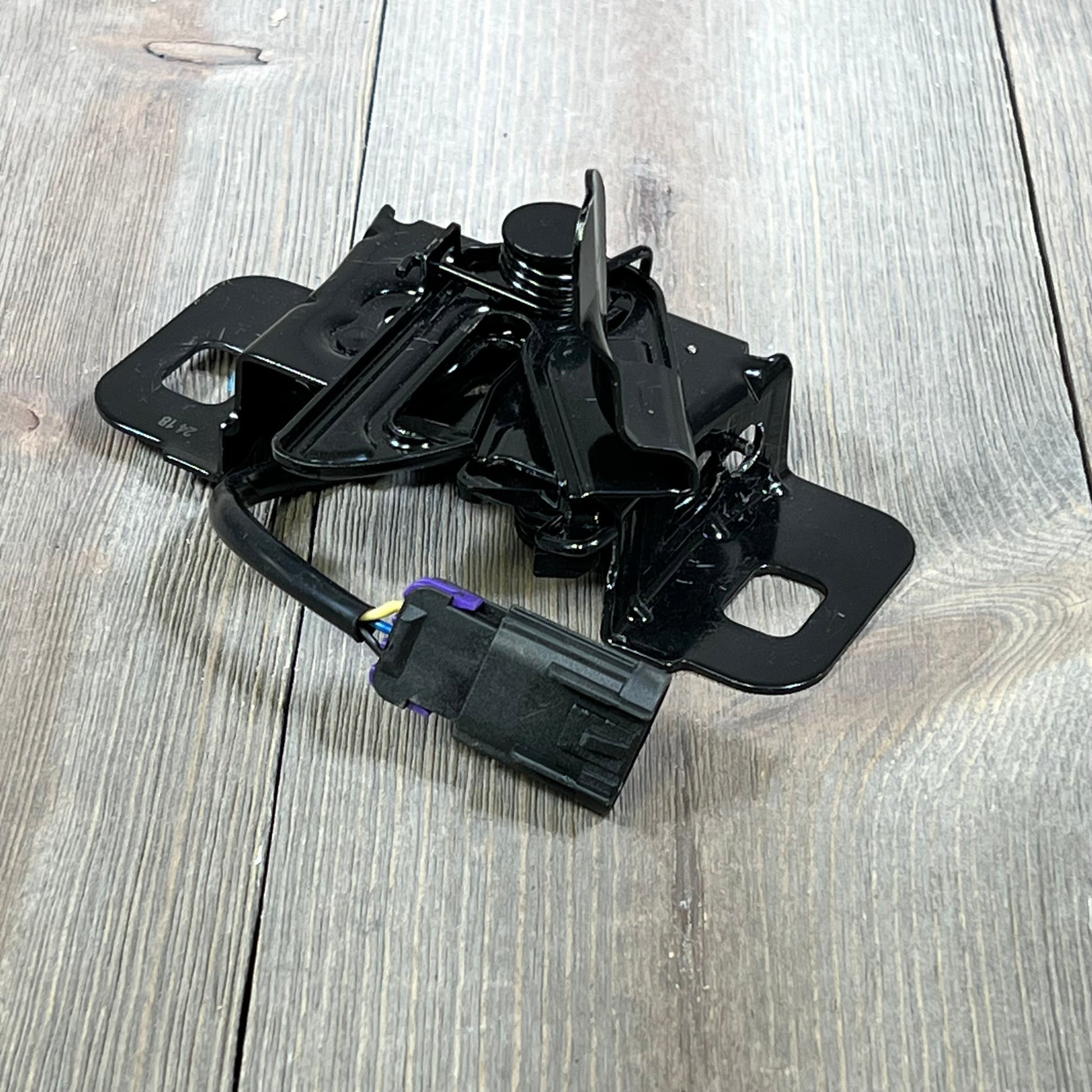 Black hood latch assembly for 2015-2018 Chevy Tahoe, part number GM1234115, with wiring connector visible.