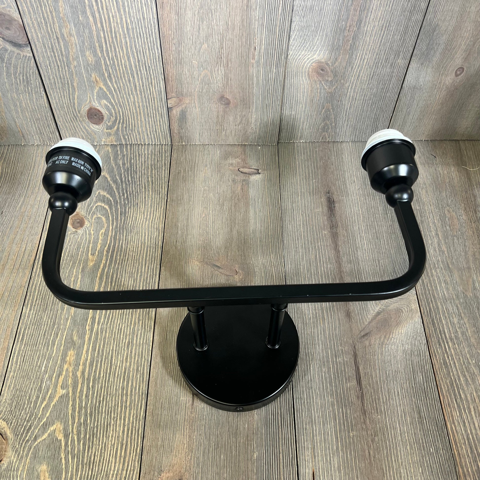 Matte black 2-light bathroom vanity fixture with modern design, ideal for elegant home decor in bathrooms and hallways.