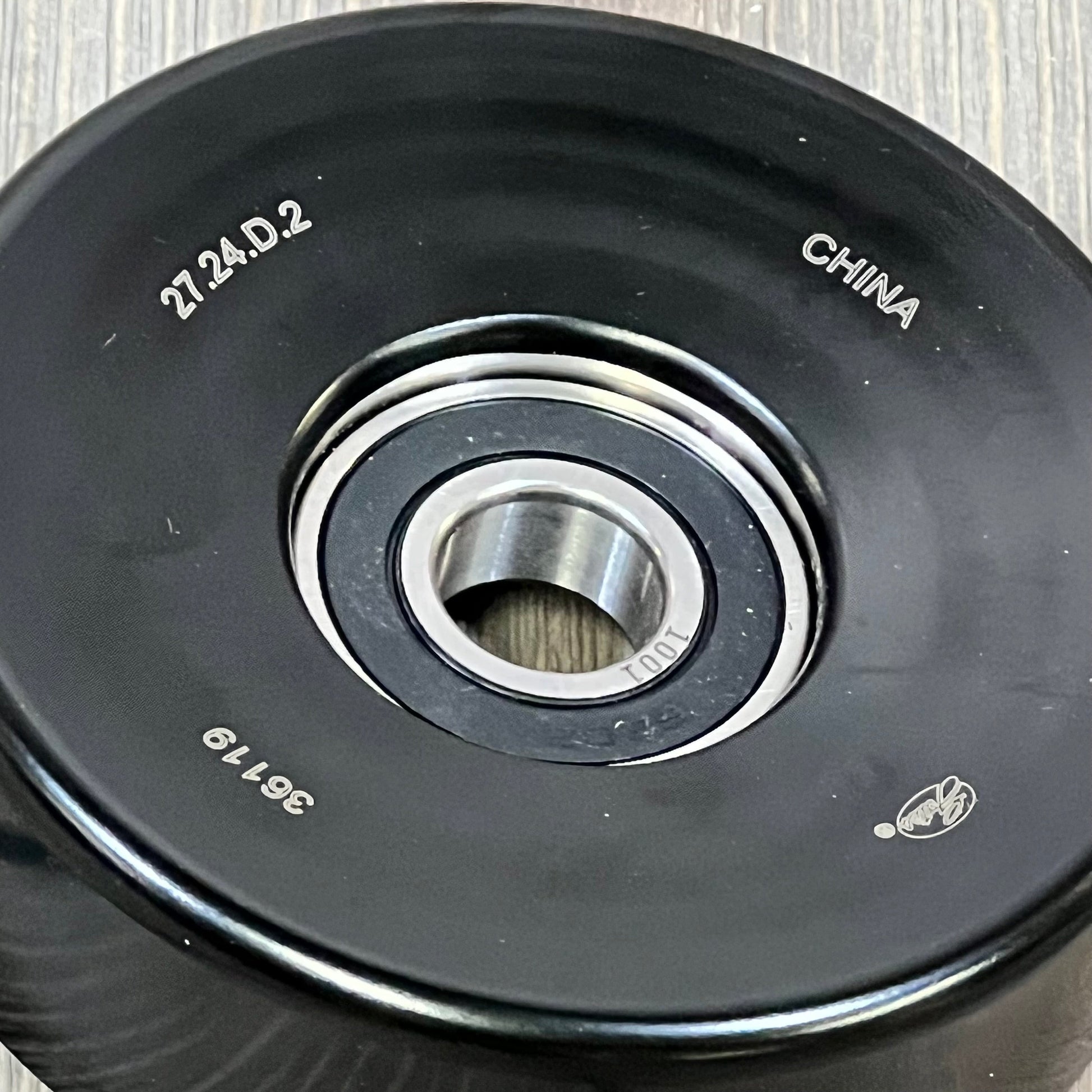 Close-up of ACDelco Gold 36119 Idler Pulley with engraved details, showing durable metal construction and smooth finish.
