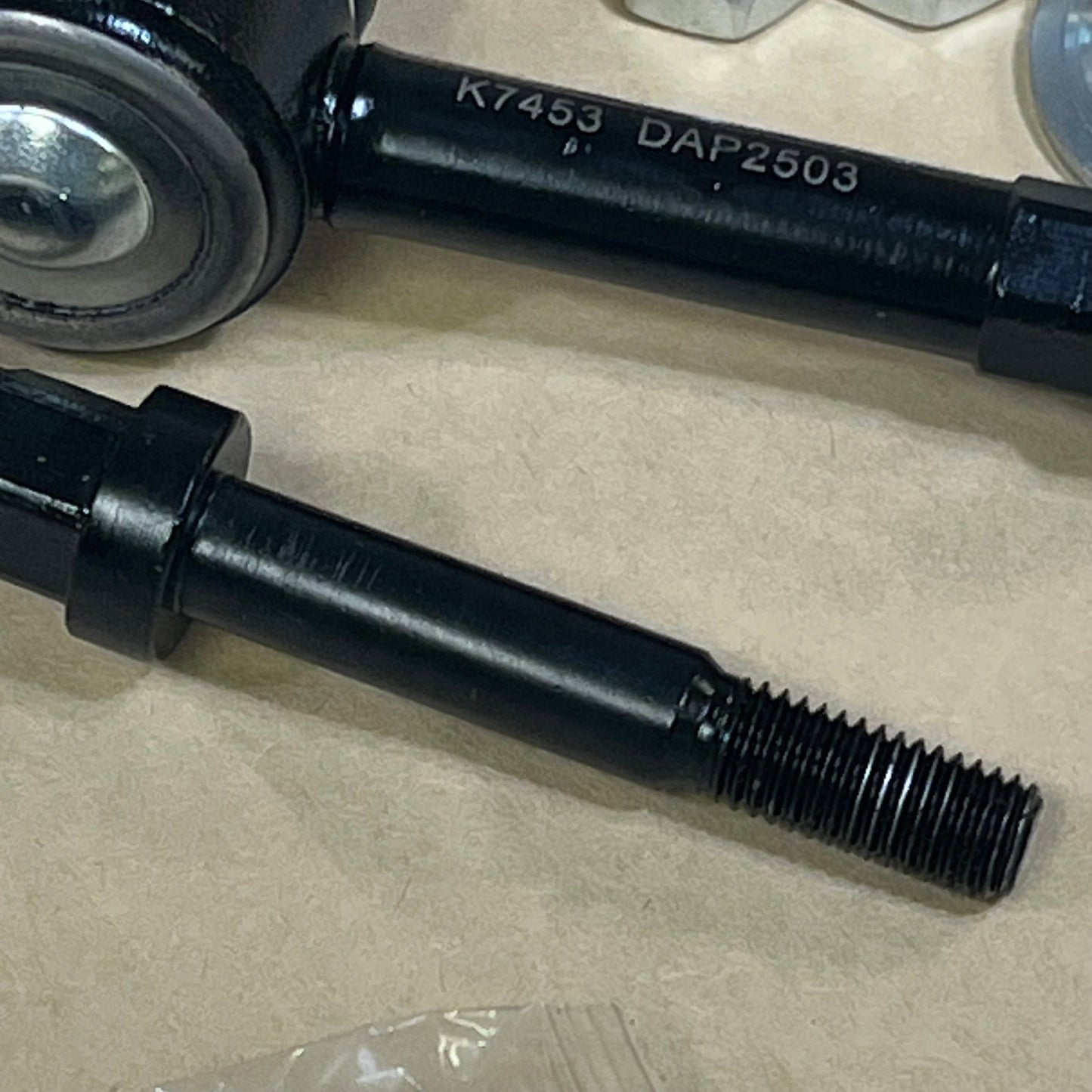 Close-up of 1046010420-DEARMMGG K7453 sway bar link for Dodge Ram 1500, showcasing durable black metal design.