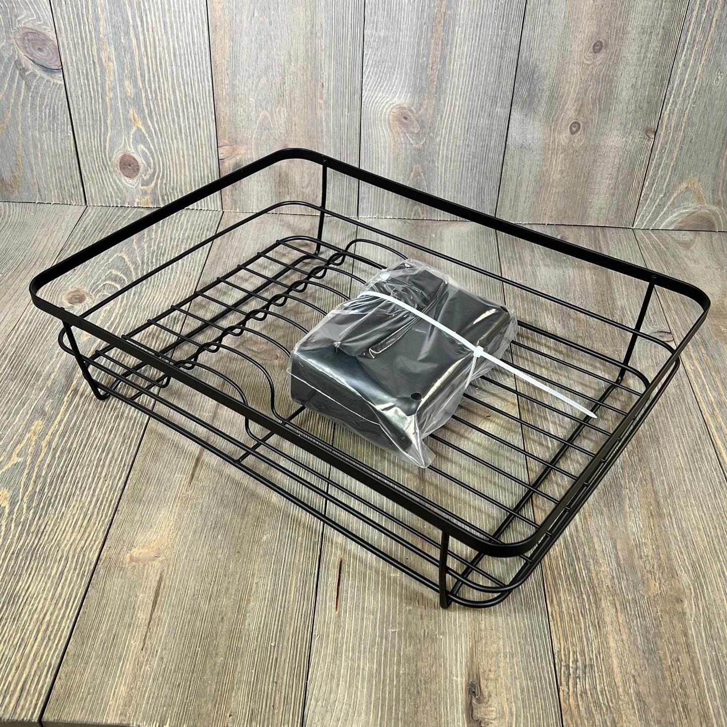 Space-saving Kitsure dish drying rack in black with cutlery holder, ideal for kitchen counters.