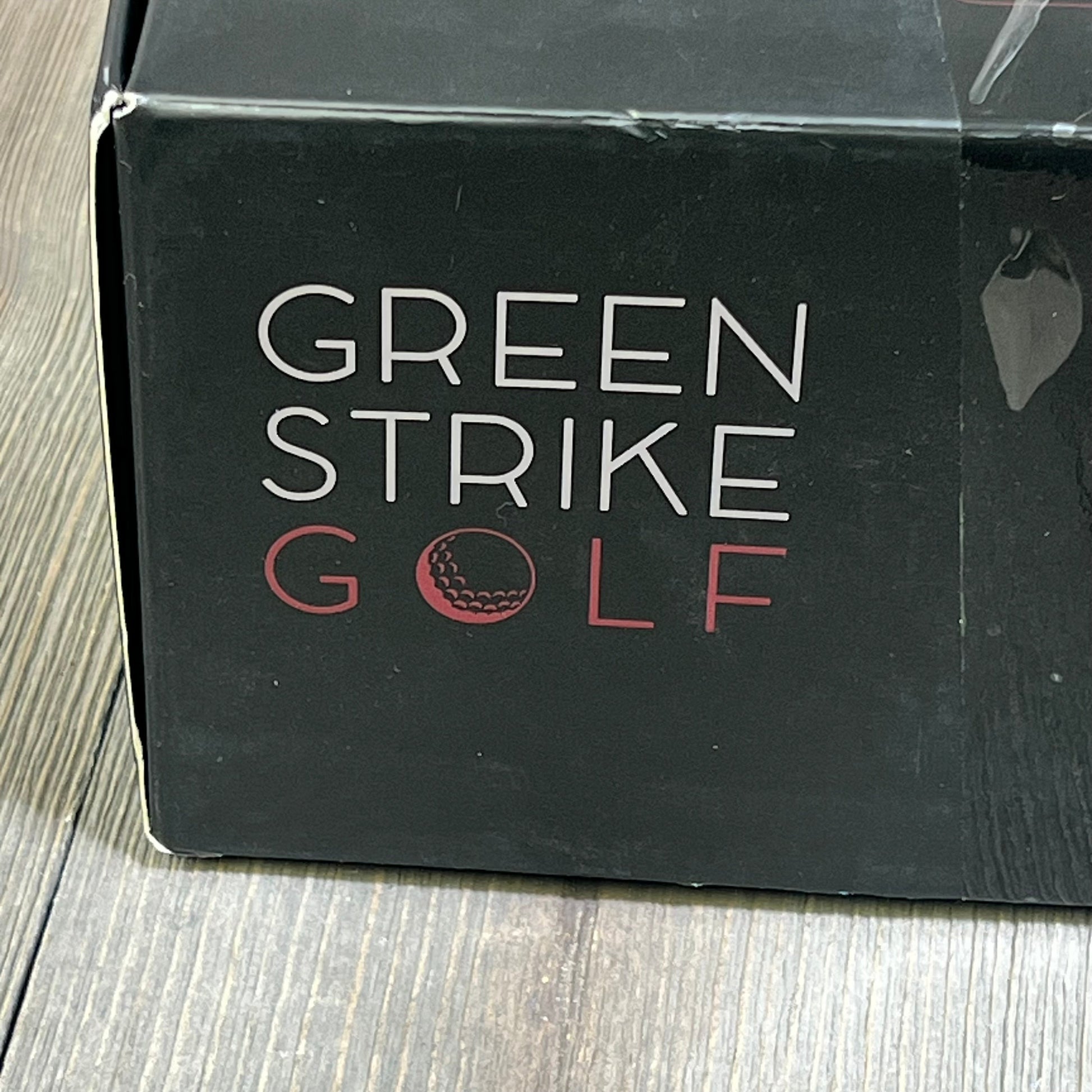 Close-up of the Green Strike Golf branding on the WOLVIO Premium Golf Bag Cooler Sleeve packaging, emphasizing premium quality.