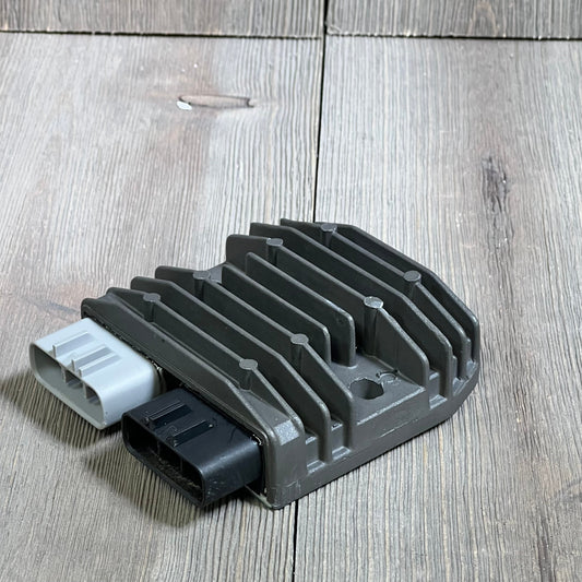 Yamaha voltage regulator rectifier with dual connectors on wooden surface, compatible with Grizzly and Rhino models.